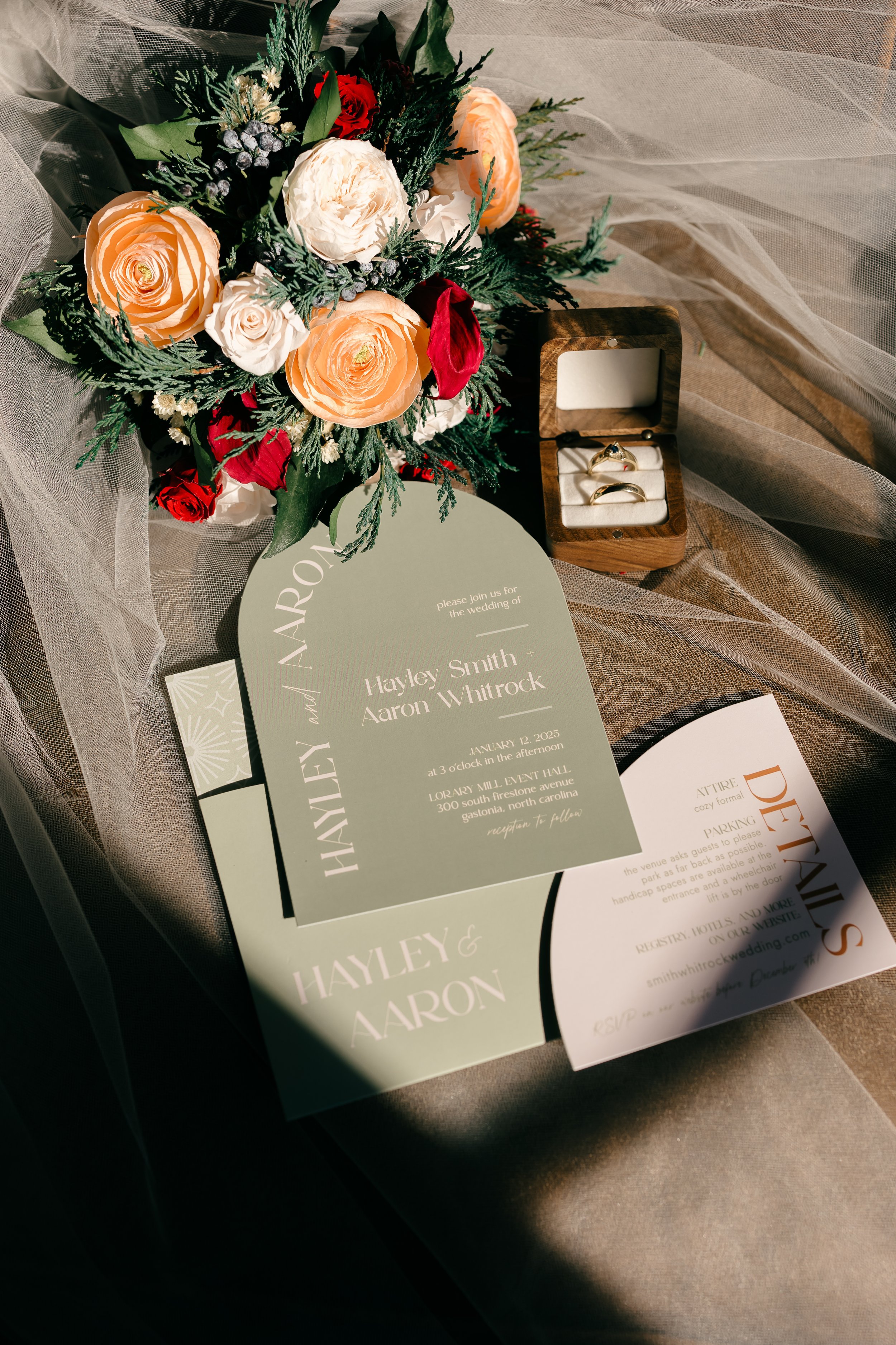 Elegant flat lay of wedding invitations, rings, and floral bouquet in soft peach and sage tones — coordinated by Charlotte Wedding Coordinator.