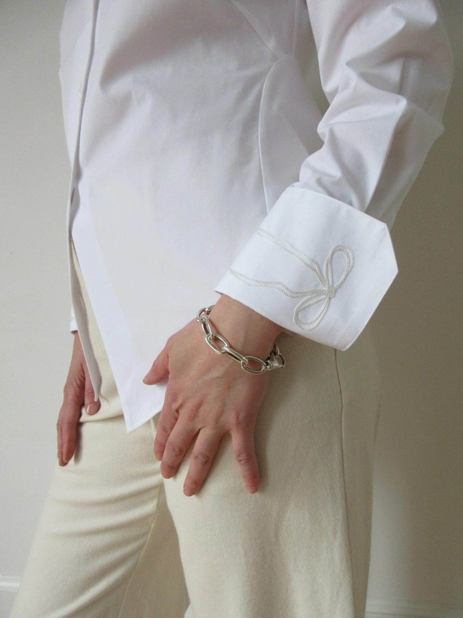Bow embroidery on a white button-up shirt