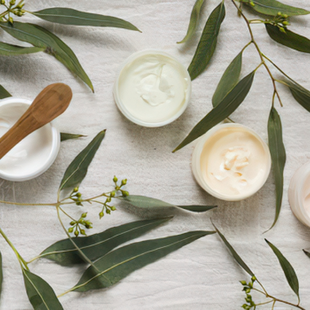 Natural body creams with eucalyptus leaves for botanical body care.