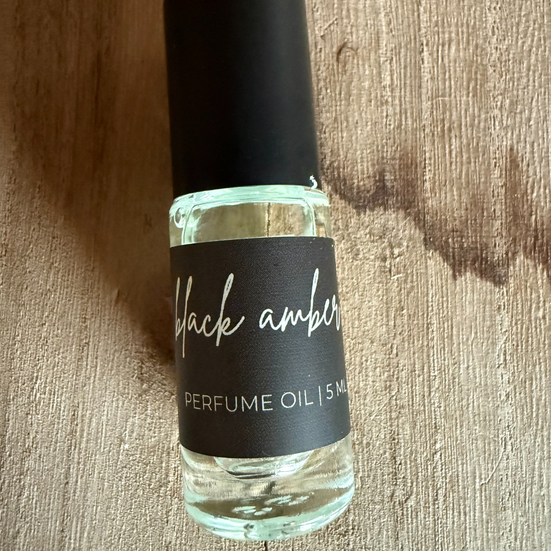 Mamas Blooming Black Amber Perfume Oil Roller in a roll-on bottle.