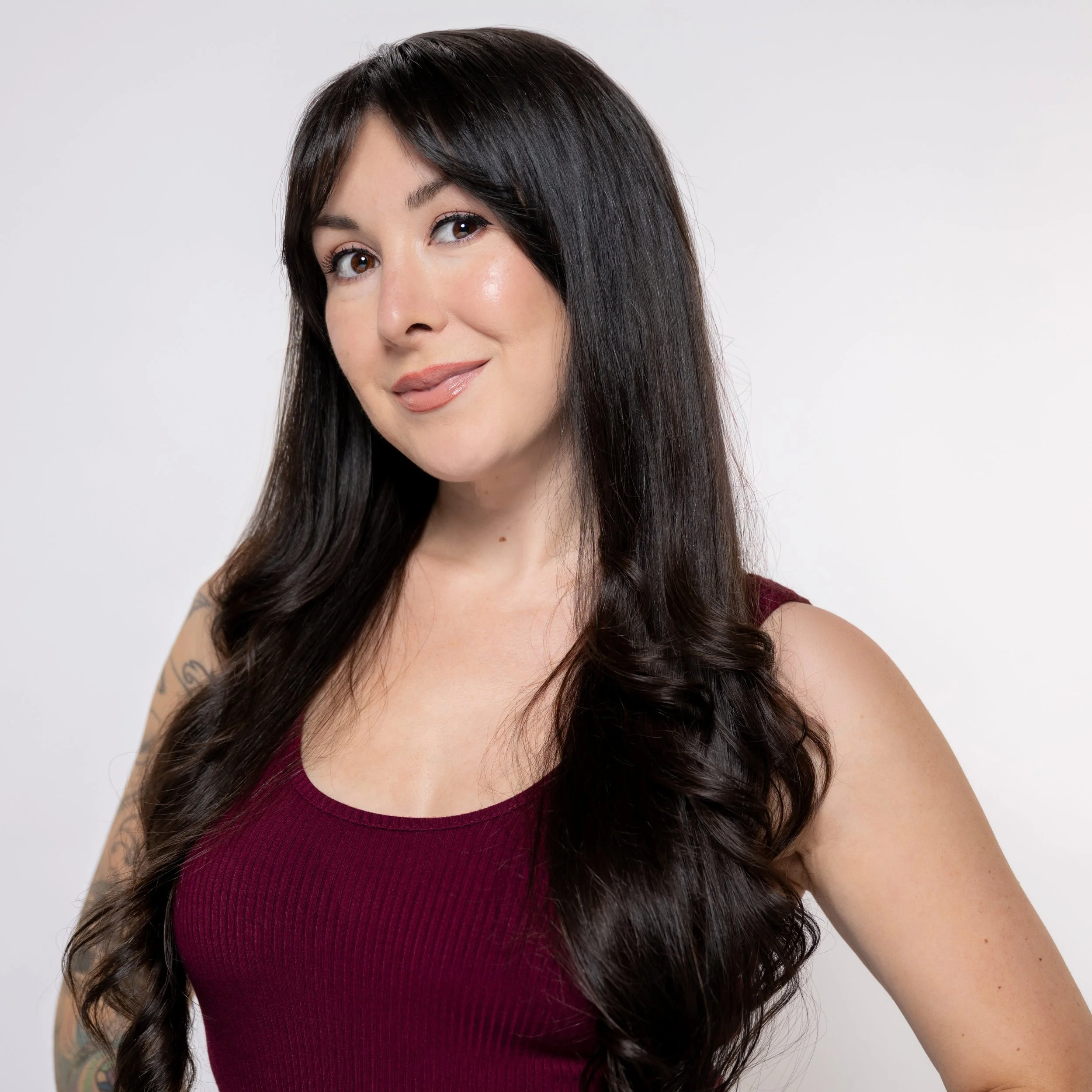 Person writing in a spiral-bound planner with black pen, surrounded by office supplies, planning your next special occasion.