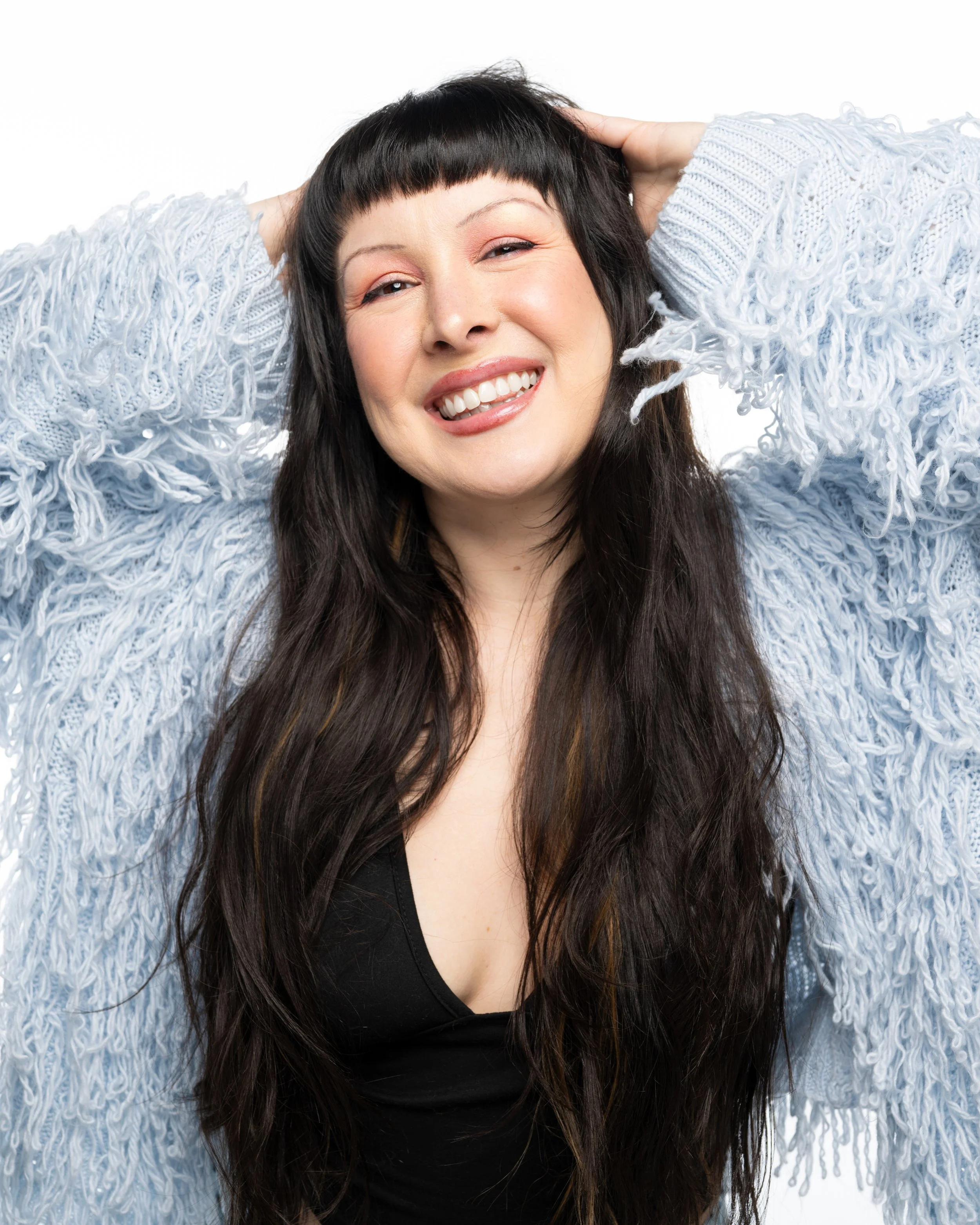 Person writing in a spiral-bound planner with black pen, surrounded by office supplies, planning your next special occasion. 