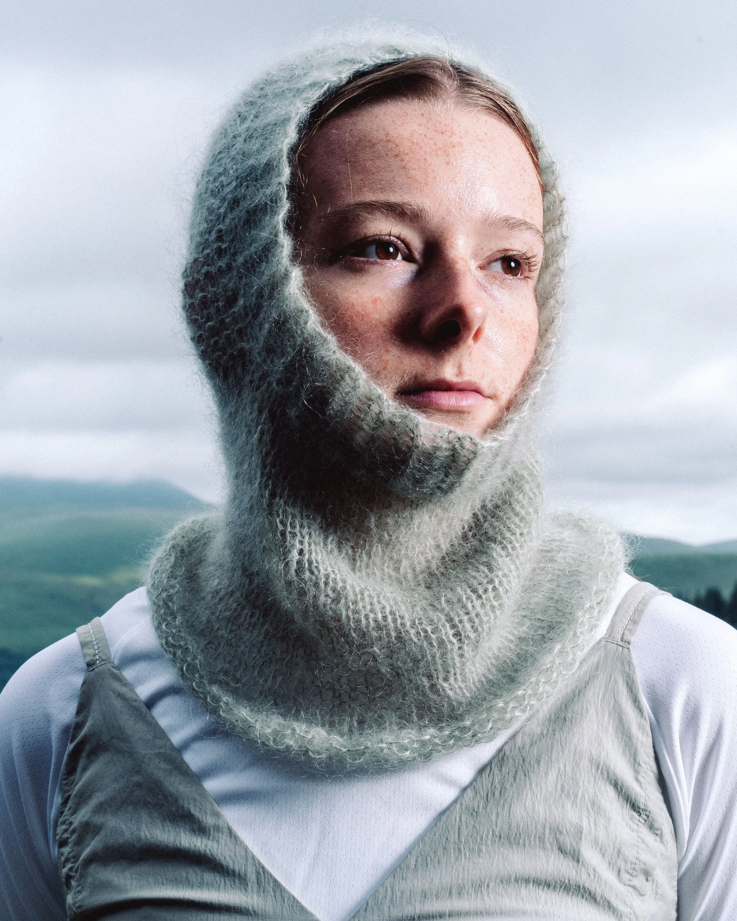 Vidda Hood: a lightweight, open-knit hood with a relaxed drape, made for in-between seasons, offering a little warmth when the wind picks up.