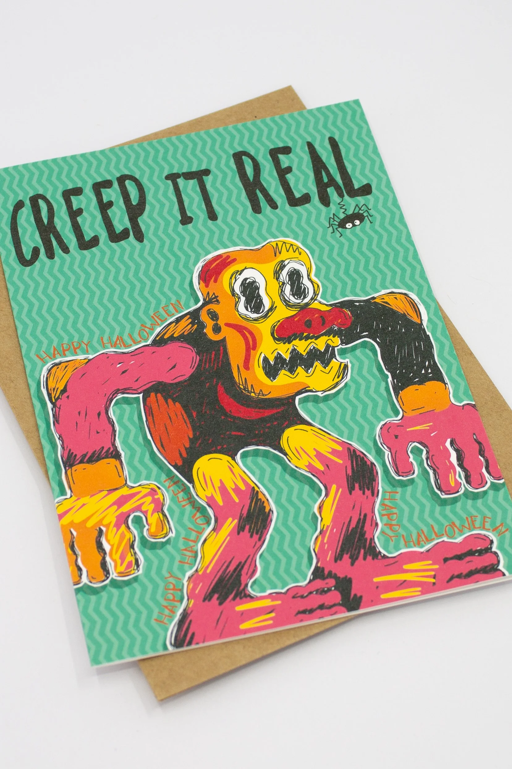 This funny Halloween greeting card features a brightly colored monster and the delightfully groan-worthy message, "Creep it Real."