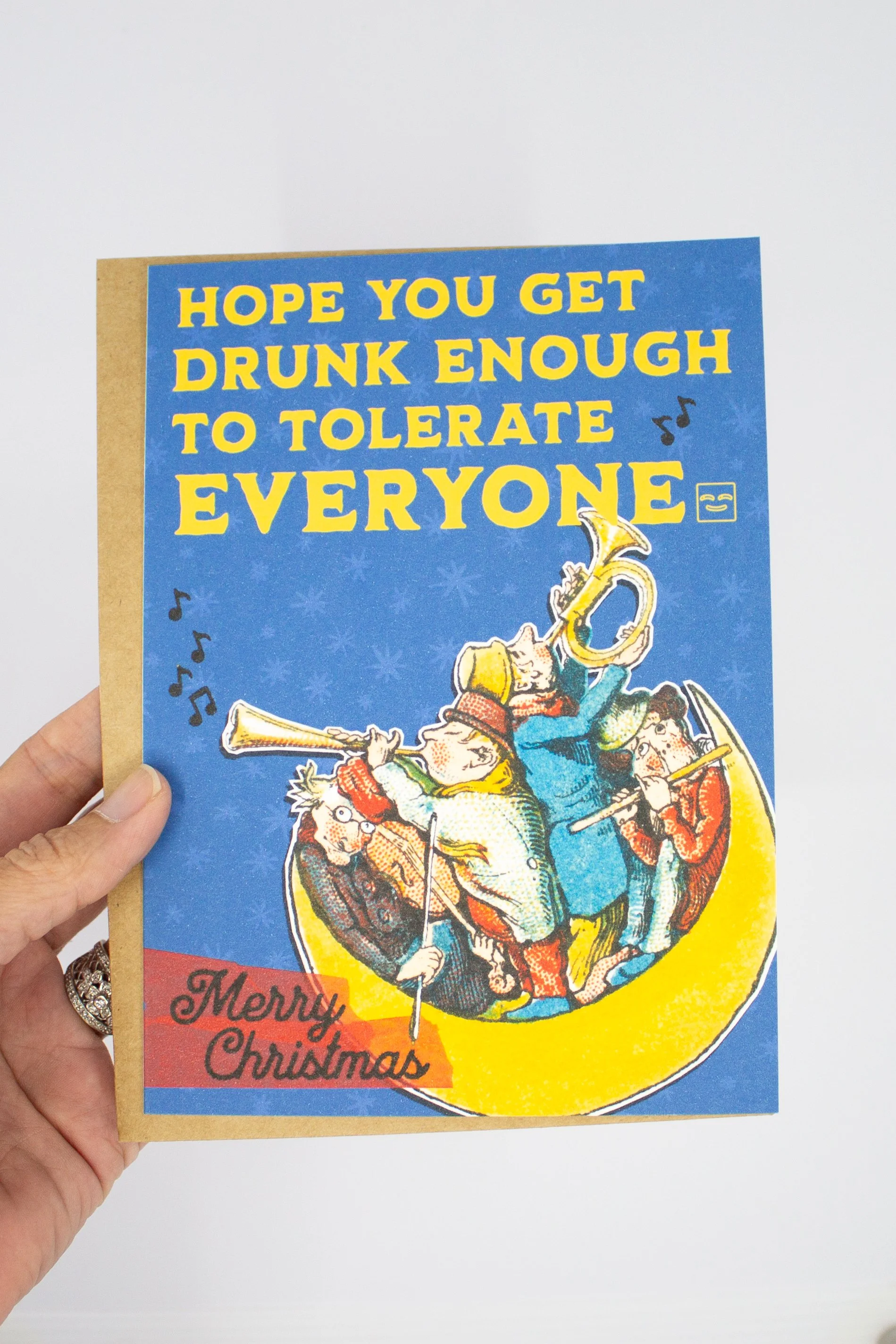 This funny Christmas greeting card features a delightfully bizarre vintage illustration of people playing musical instruments on the moon