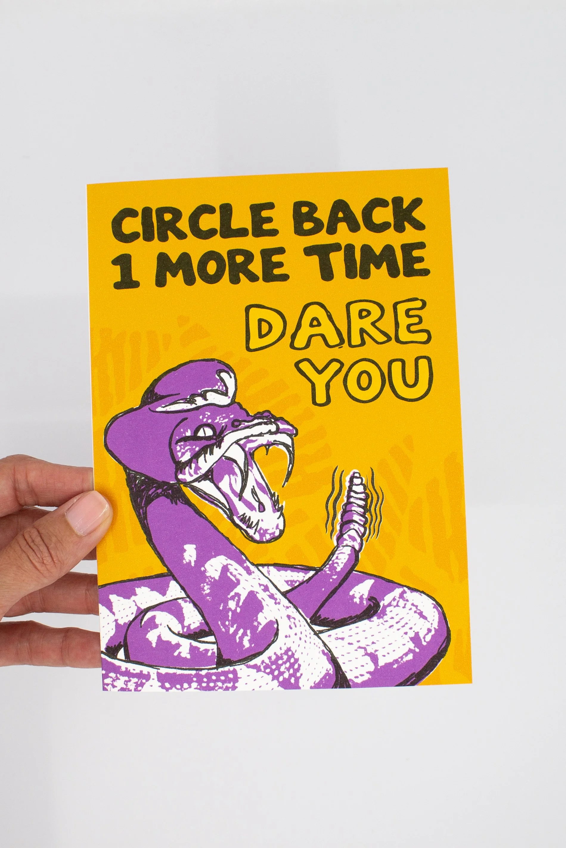 bold graphic of a coiled rattlesnake poised to strike