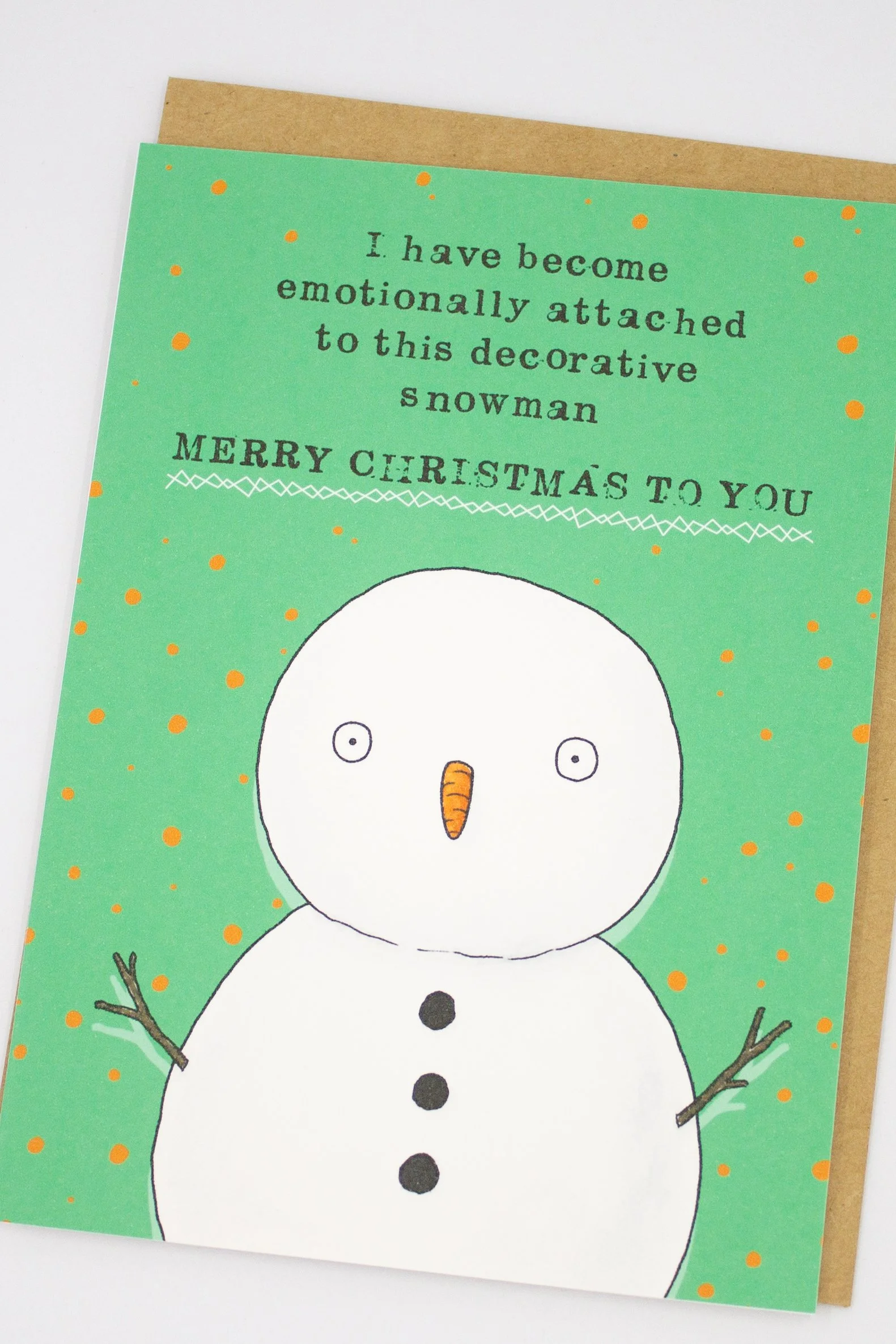 Funny Christmas greeting card featuring a decorative snowman with the saying "I have become emotionally attached to this decorative snowman. Merry Christmas."