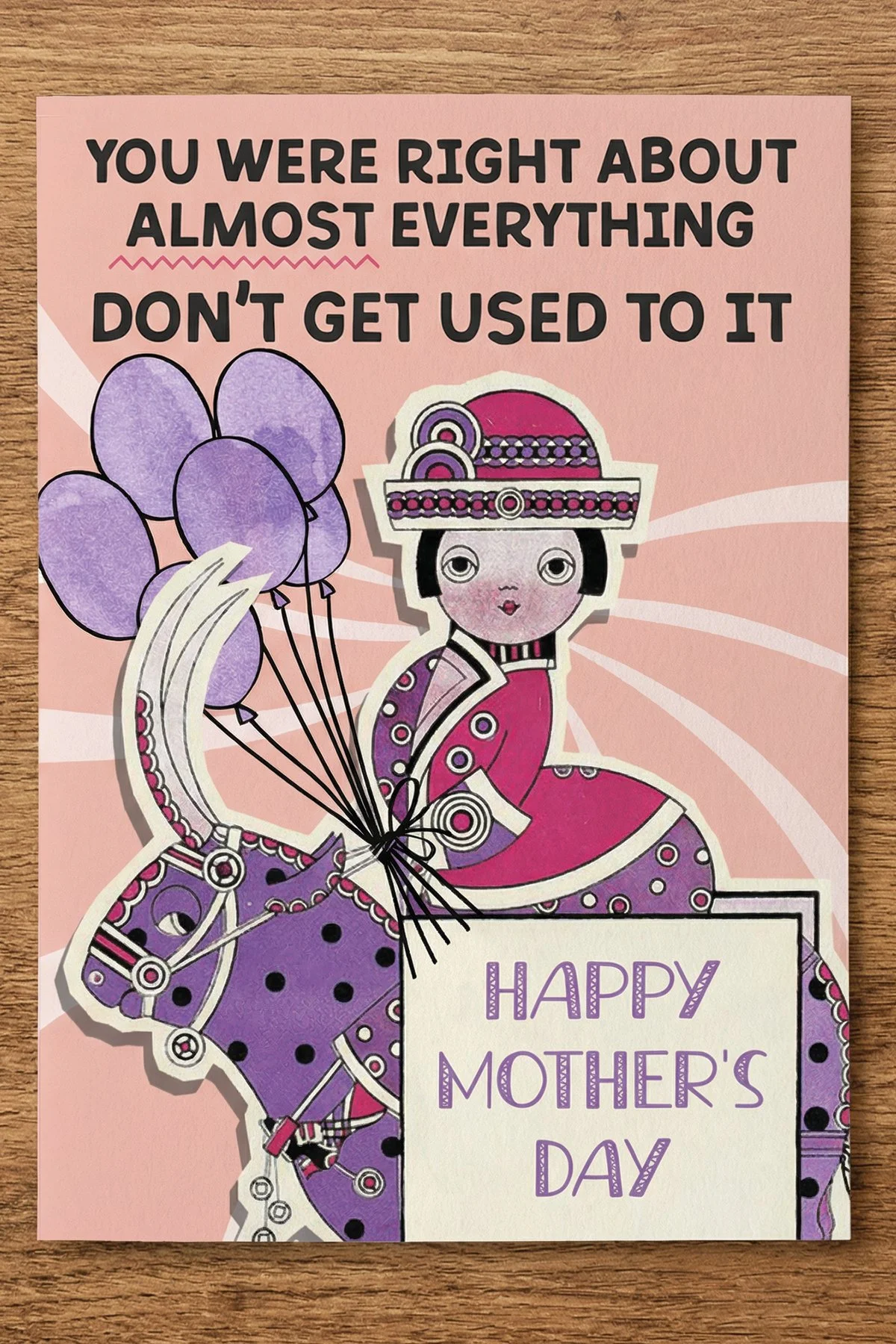 The front of this Mother's Day card features a woman in vintage dress on a bull with balloons, and the words “You were right about almost everything, don’t get used to it.”