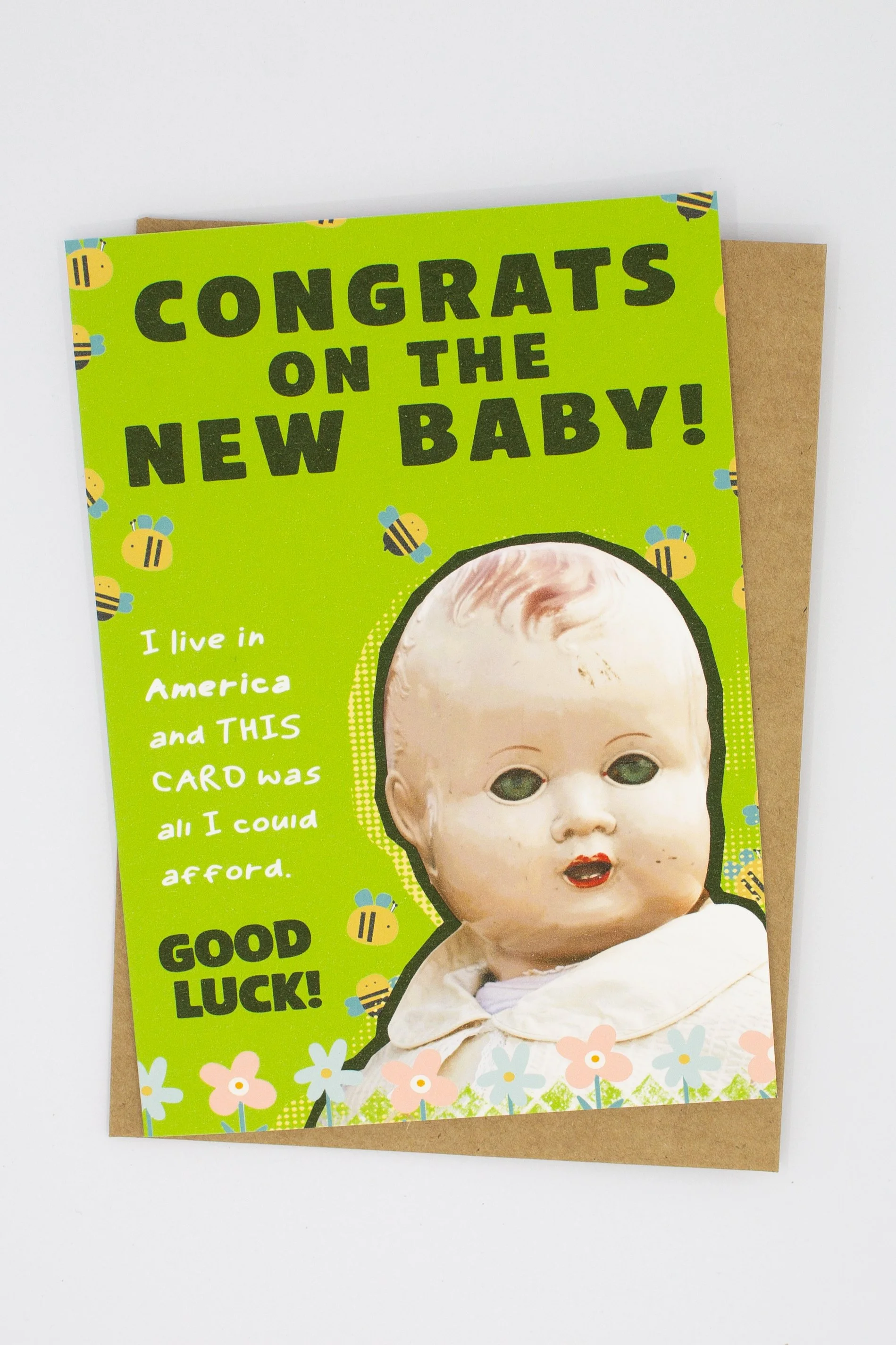 unique baby shower card featuring a delightfully creepy vintage baby doll