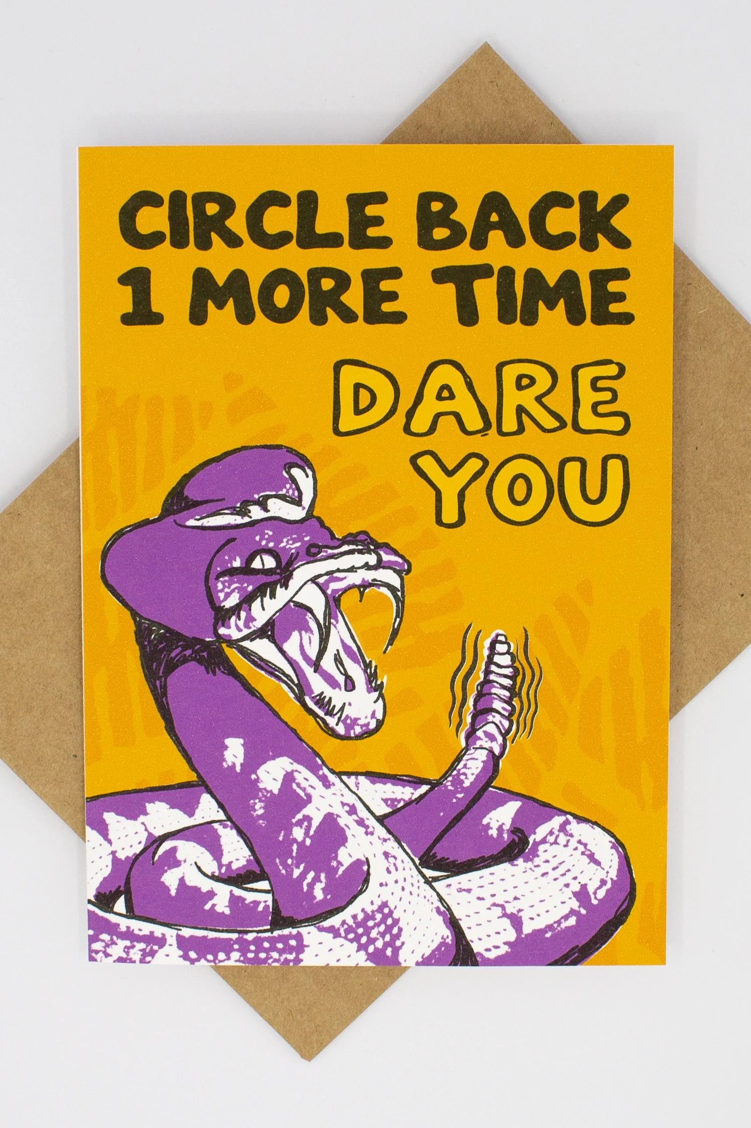 bold graphic of a coiled rattlesnake poised to strike