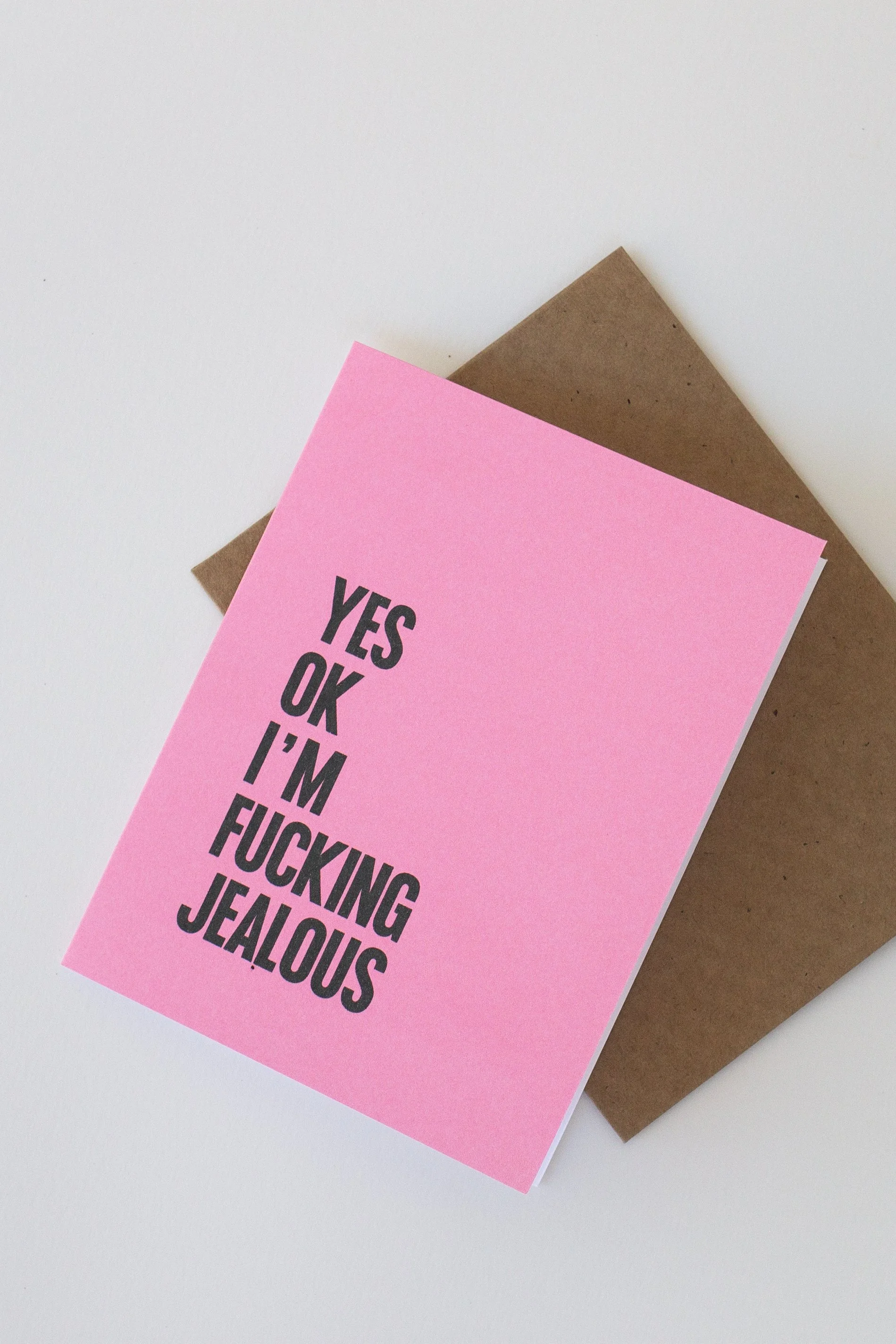The front of this pink card is a text-only phrase: “Yes ok I’m fucking jealous.” Great when you want to take accountability for your feelings.