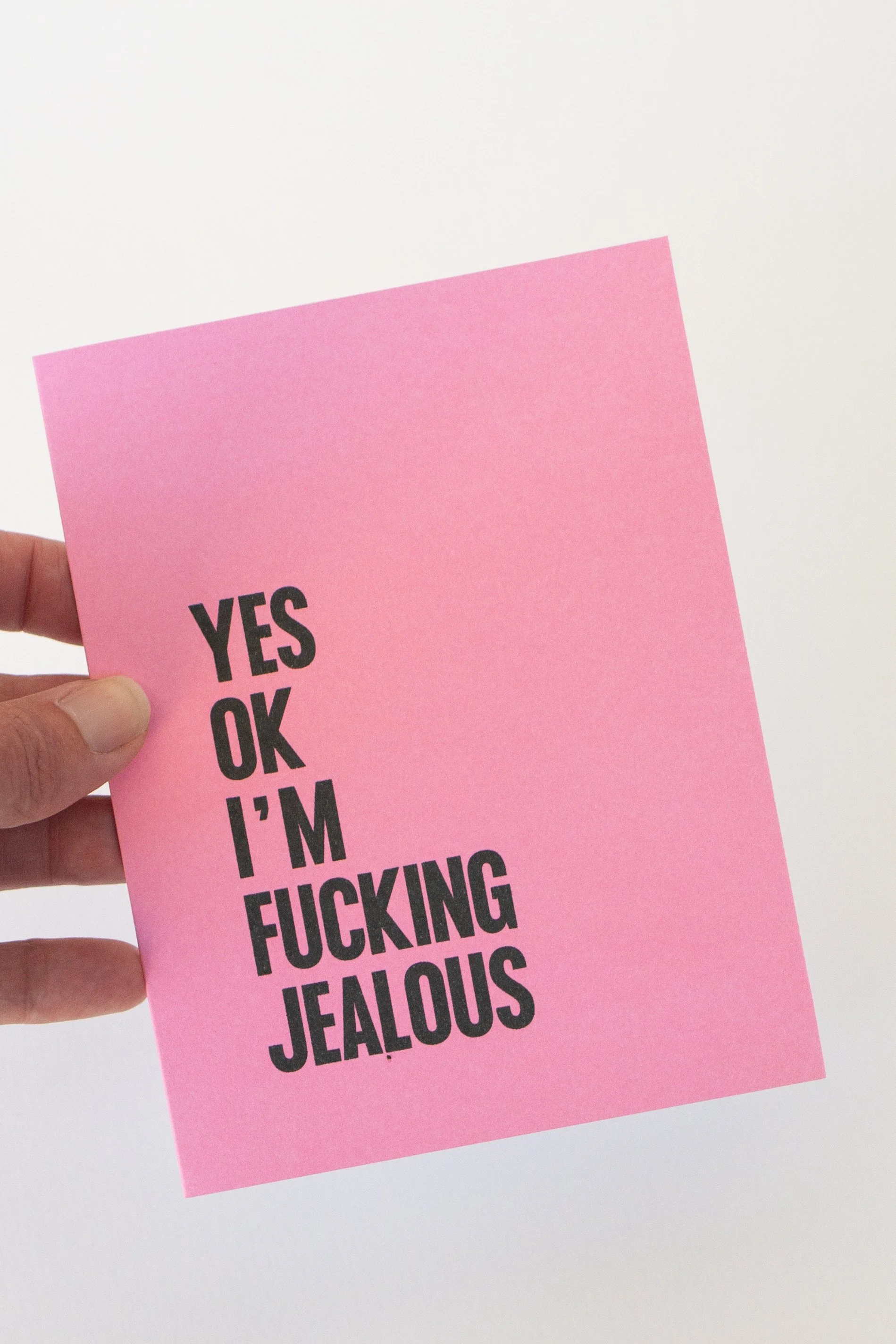 The front of this pink card is a text-only phrase: “Yes ok I’m fucking jealous.” Great when you want to take accountability for your feelings.