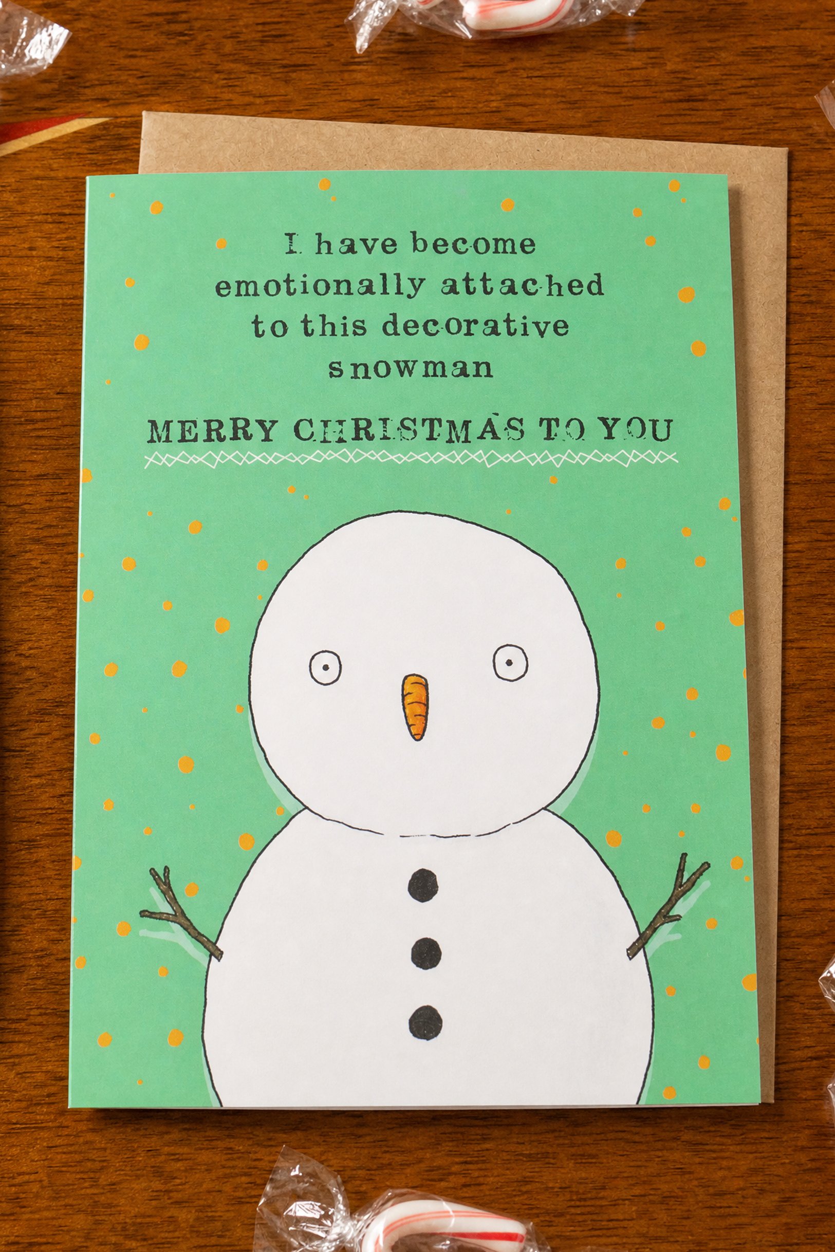 Funny Christmas greeting card featuring a decorative snowman with the saying "I have become emotionally attached to this decorative snowman. Merry Christmas."