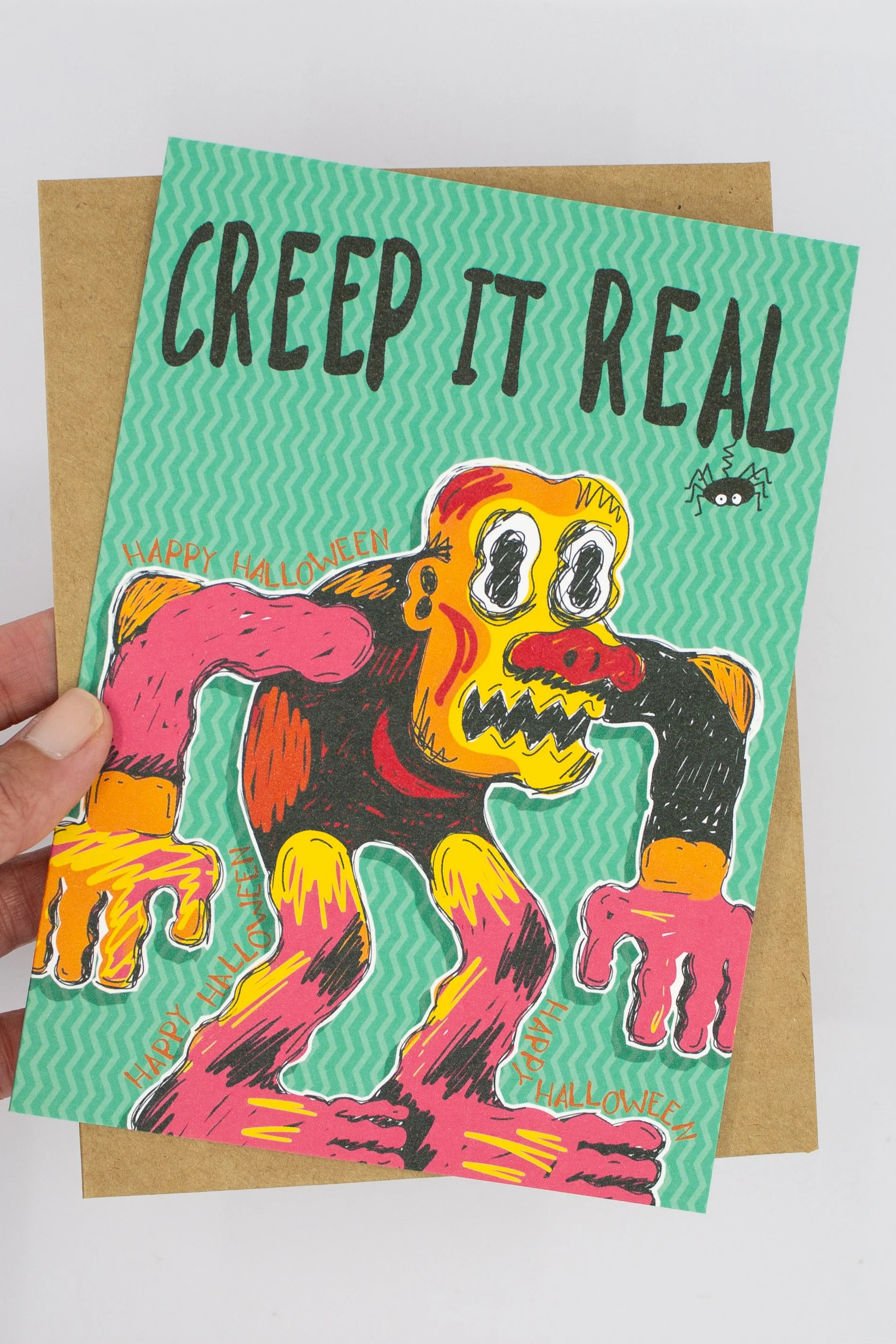 This funny Halloween greeting card features a brightly colored monster and the delightfully groan-worthy message, "Creep it Real."