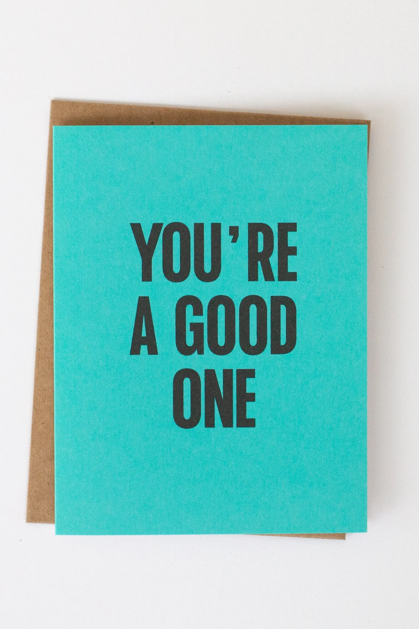 The front of this turquoise card is a text-only phrase: “You’re a Good One.”