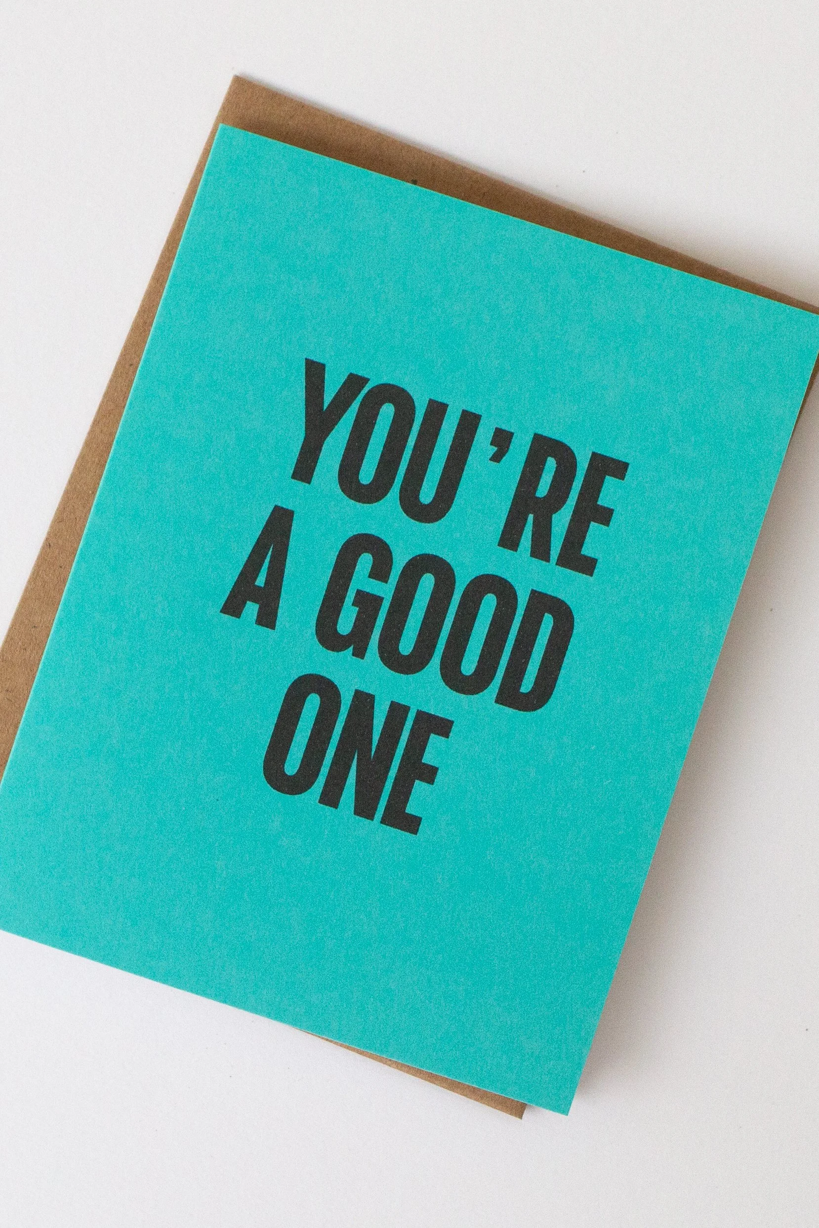 The front of this turquoise card is a text-only phrase: “You’re a Good One.”