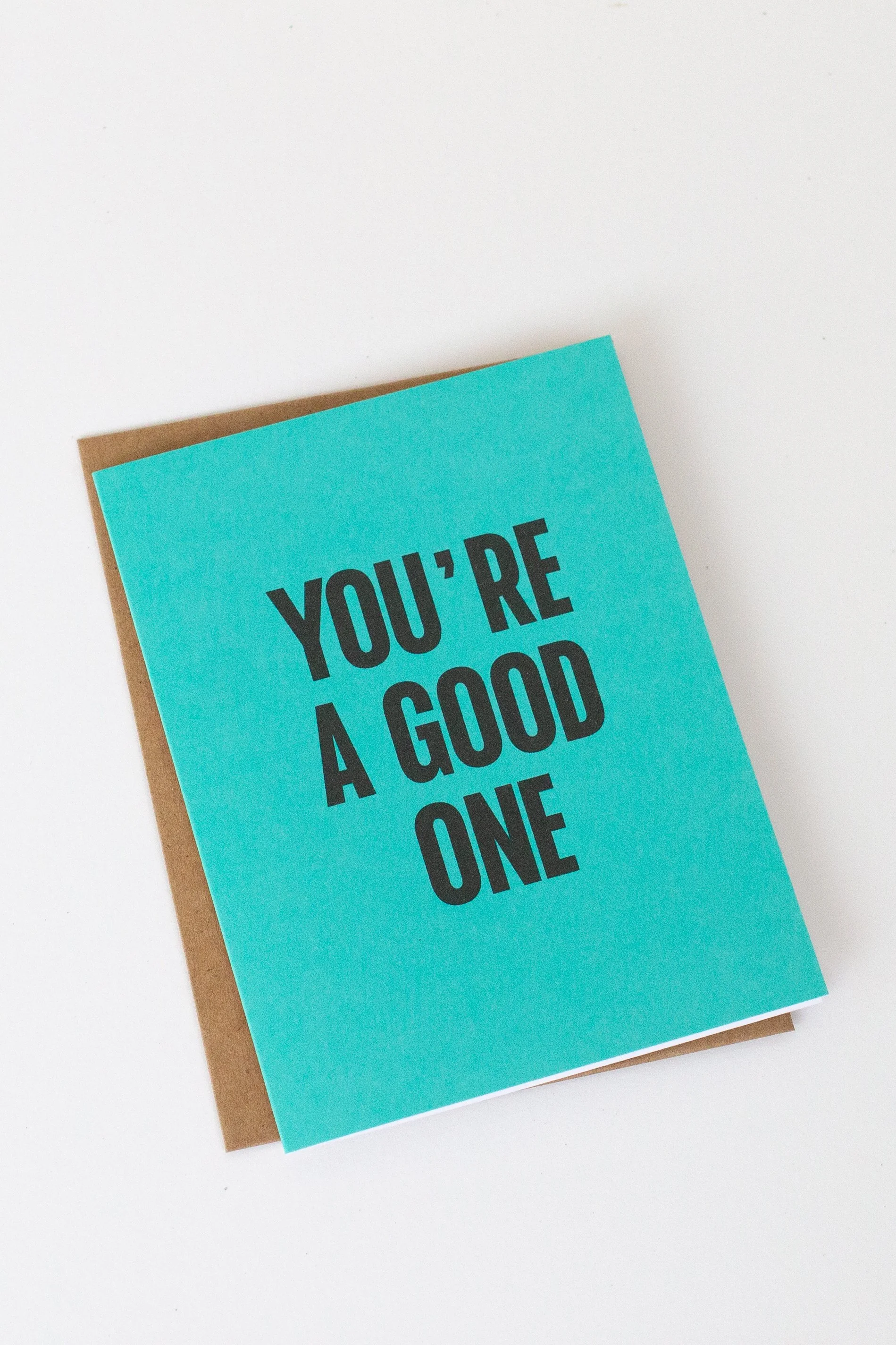 The front of this turquoise card is a text-only phrase: “You’re a Good One.”