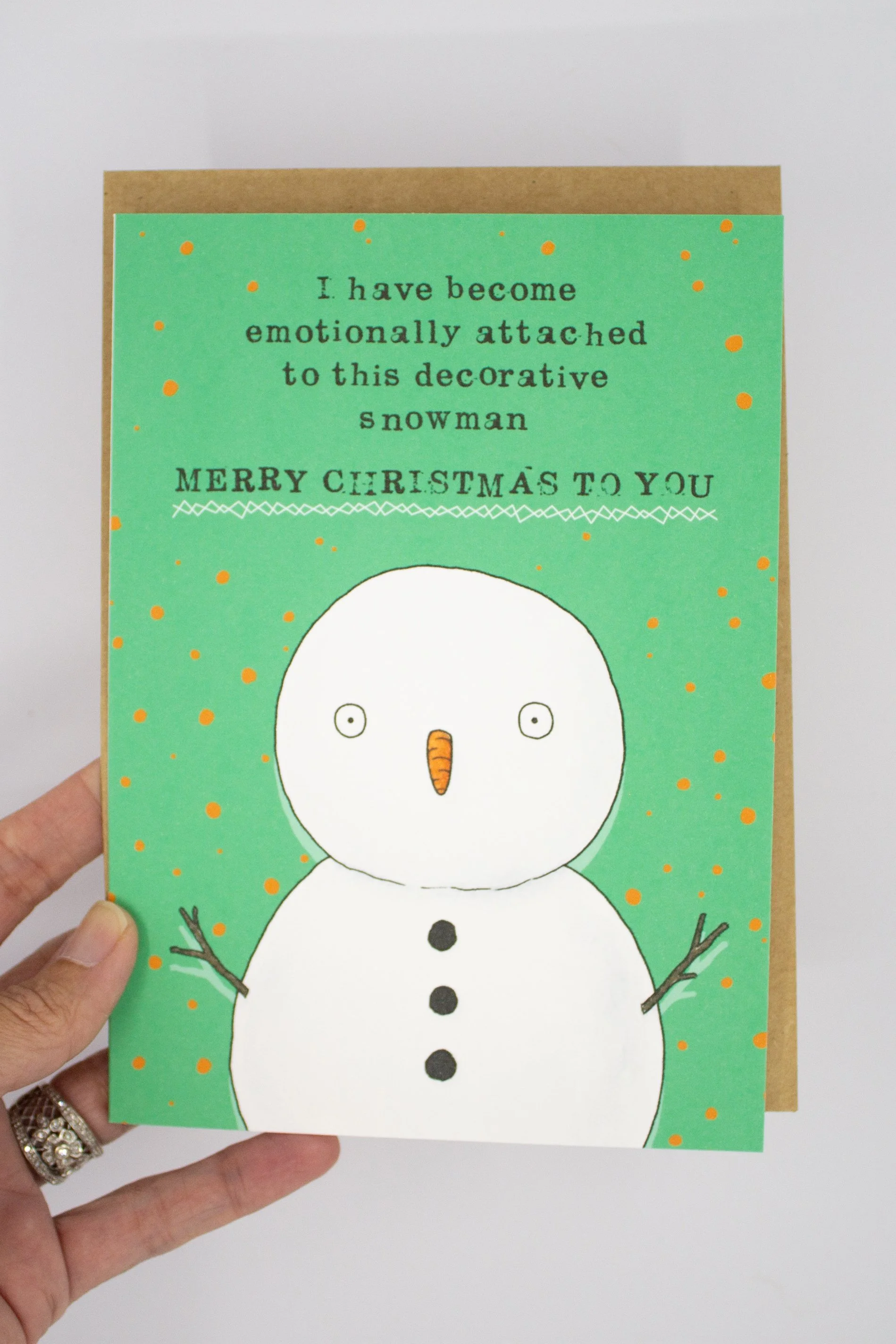 Funny Christmas greeting card featuring a decorative snowman with the saying "I have become emotionally attached to this decorative snowman. Merry Christmas."