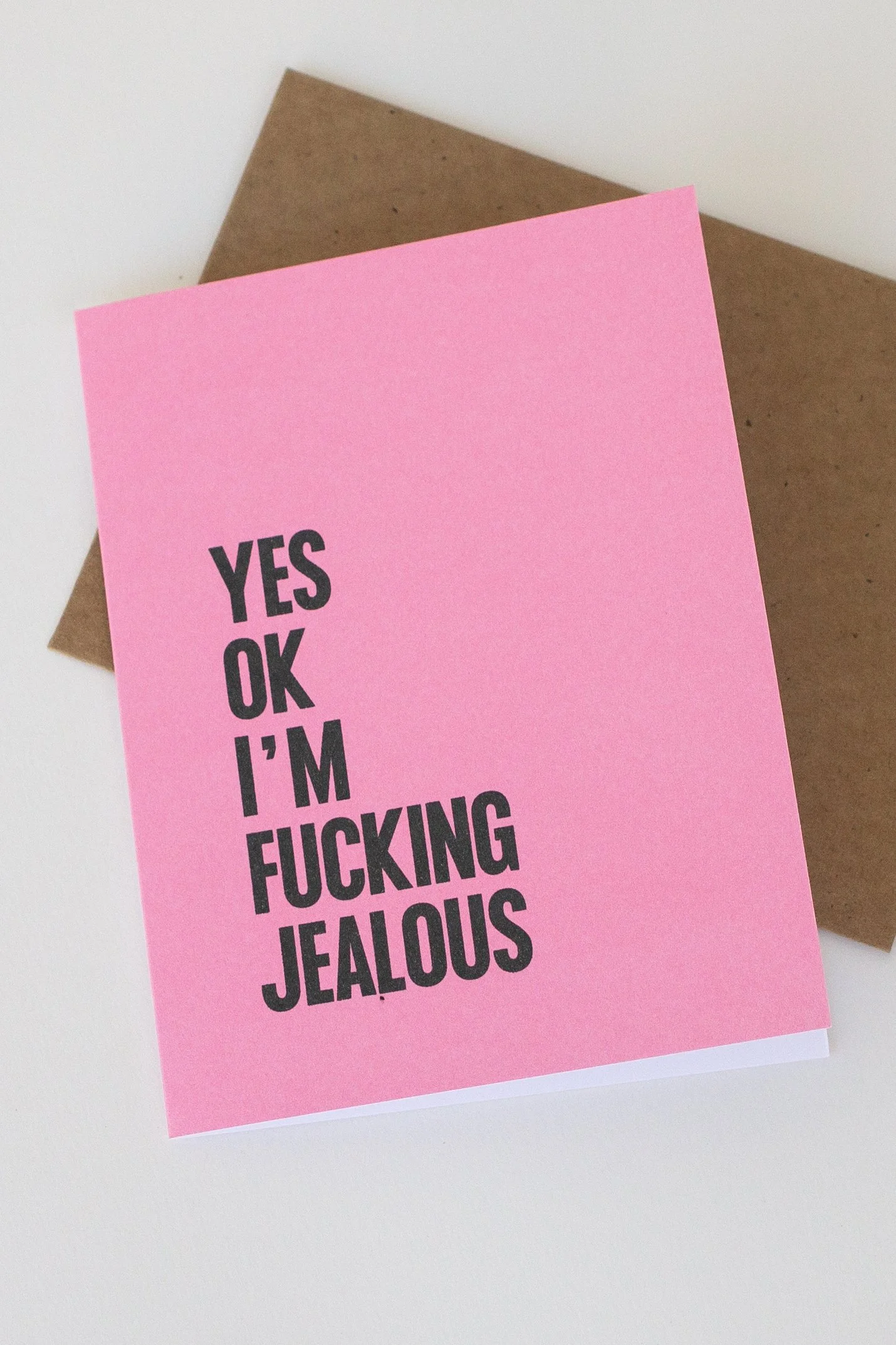 The front of this pink card is a text-only phrase: “Yes ok I’m fucking jealous.” Great when you want to take accountability for your feelings.