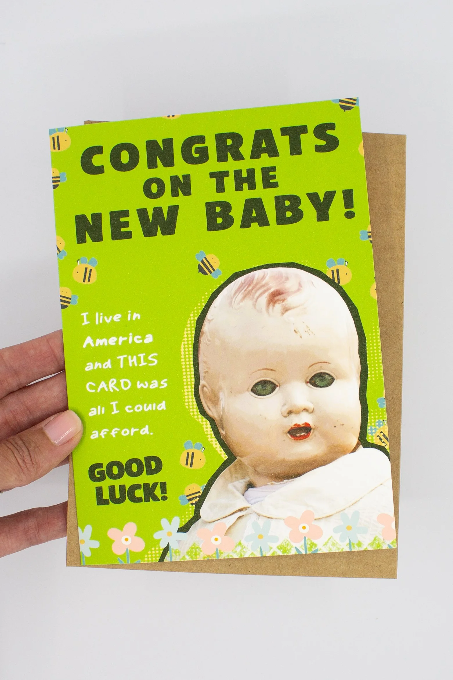 unique baby shower card featuring a delightfully creepy vintage baby doll