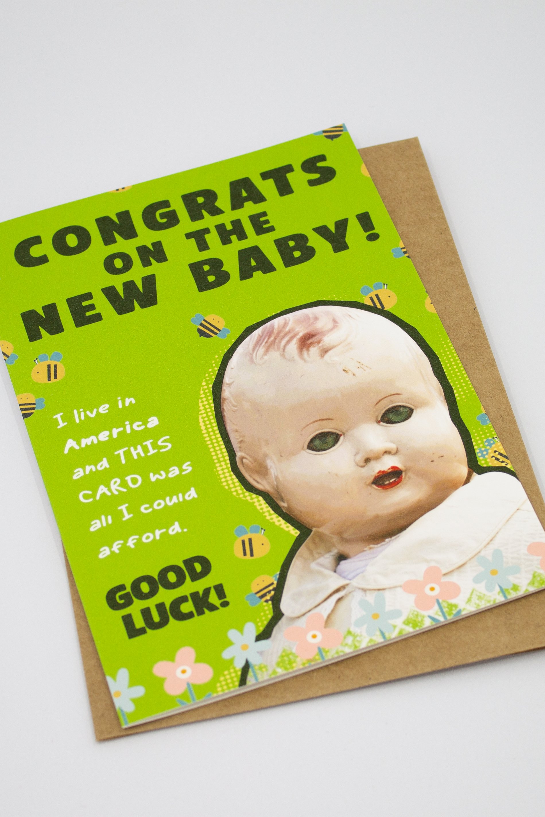 unique baby shower card featuring a delightfully creepy vintage baby doll