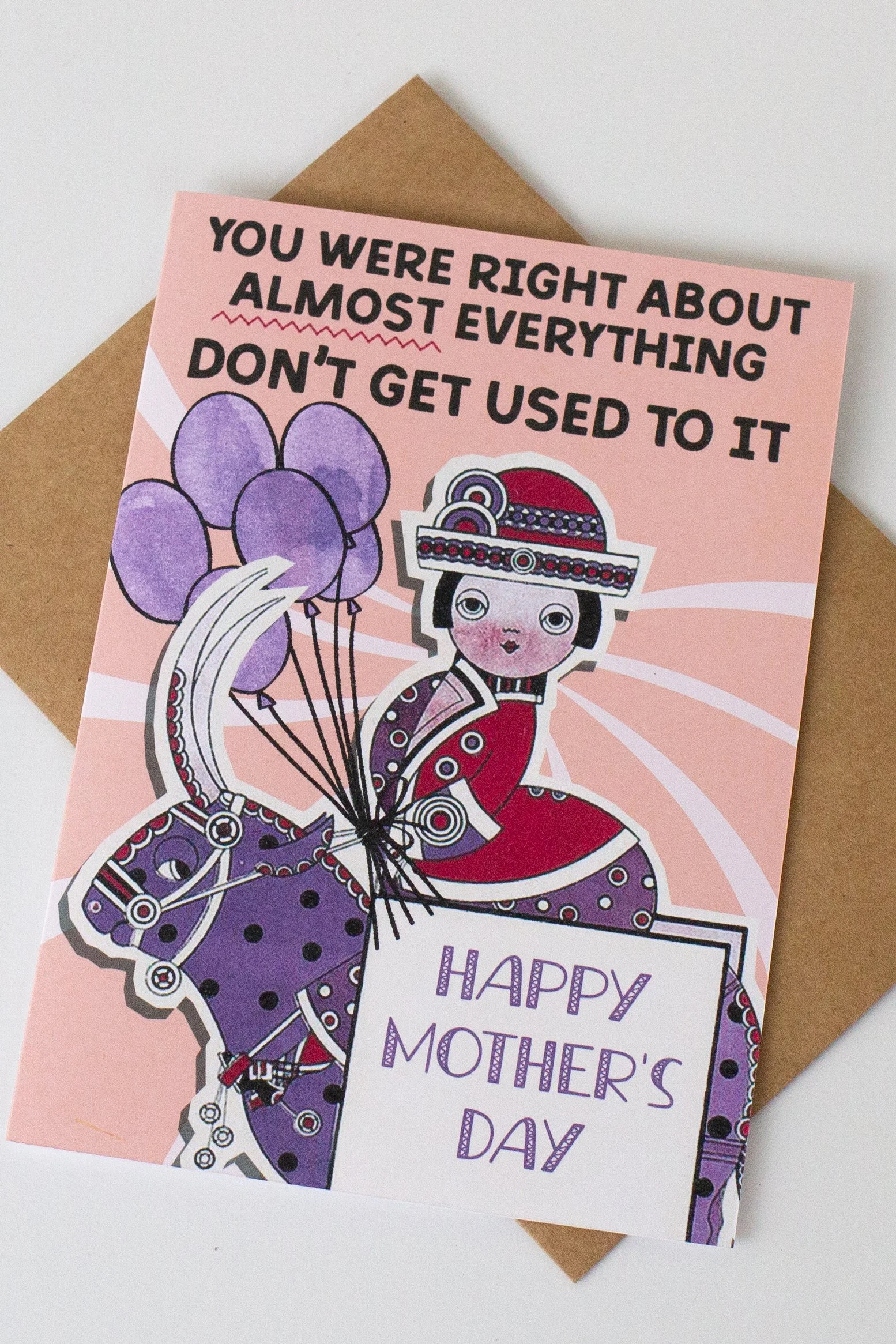 The front of this Mother's Day card features a woman in vintage dress on a bull with balloons, and the words “You were right about almost everything, don’t get used to it.”