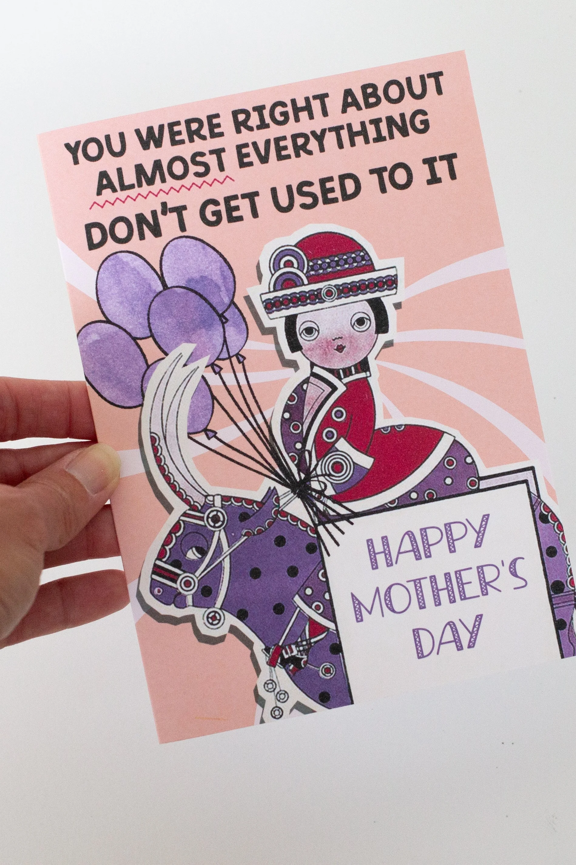 The front of this Mother's Day card features a woman in vintage dress on a bull with balloons, and the words “You were right about almost everything, don’t get used to it.”