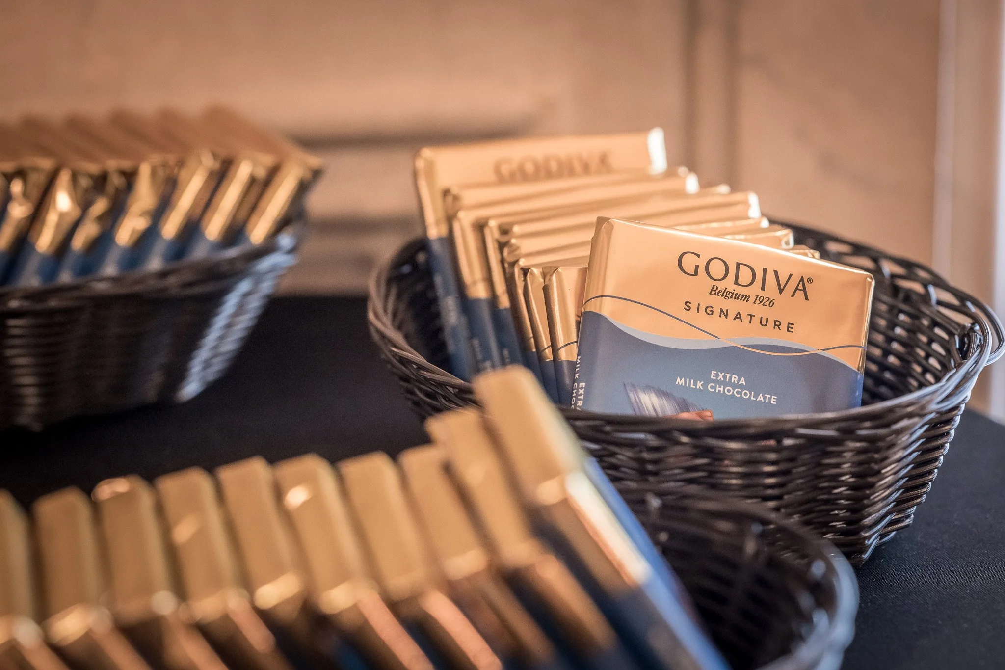 Baskets filled with Godiva chocolate bars on display.