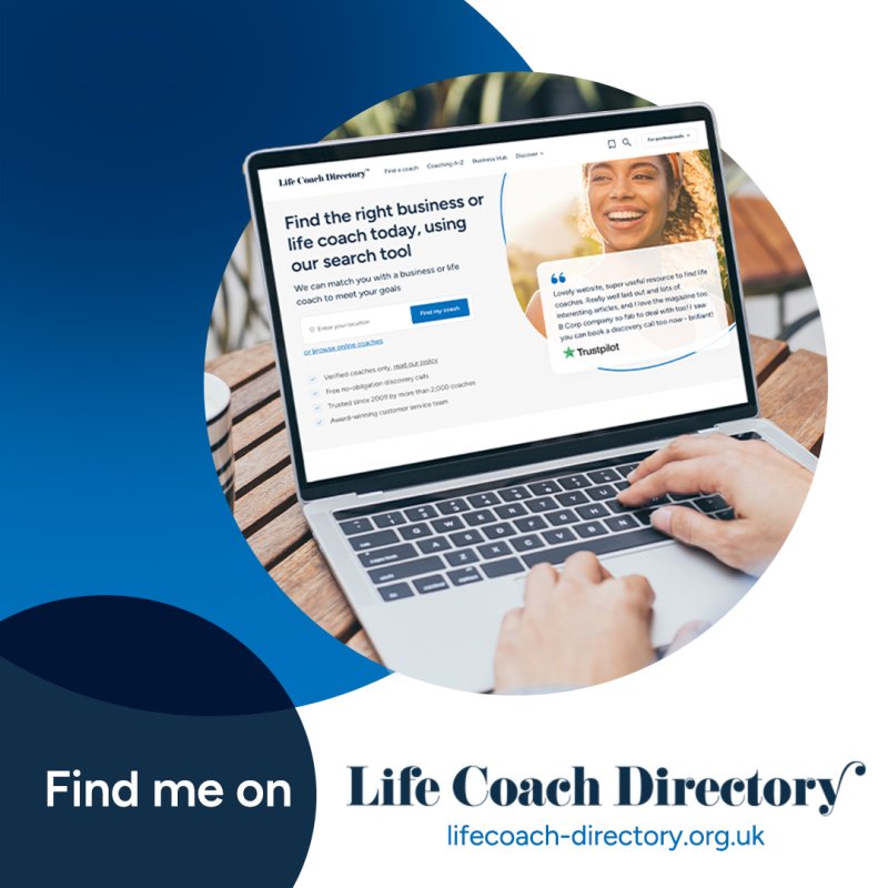 Laptop displaying the Life Coach Directory website on a wooden table.