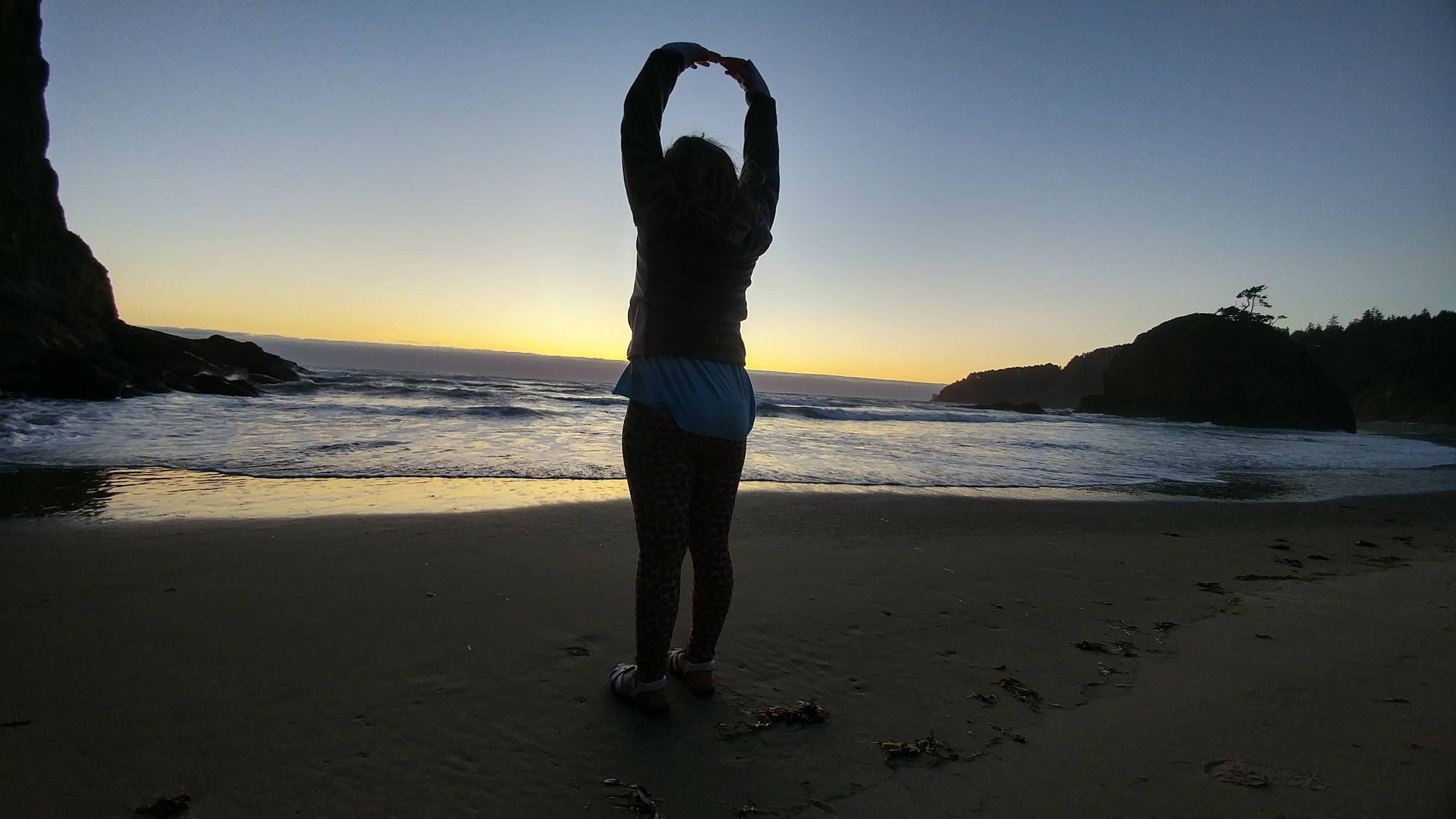 Child at the beach at sunset.
