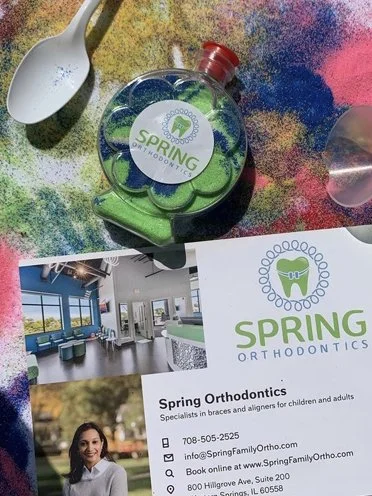 At the Western Springs “Picnic in the Park” last June, we had a sand art table! Kids came by and used their creative to make beautiful sand art of all shapes and sizes including this flower, and spoke about orthodontics! It was a really great day spe
