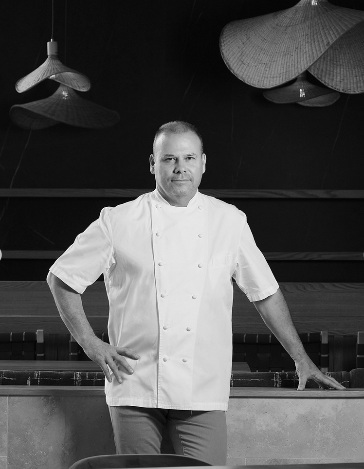 Chef Jonathan Fox standing in a restaurant dining room.