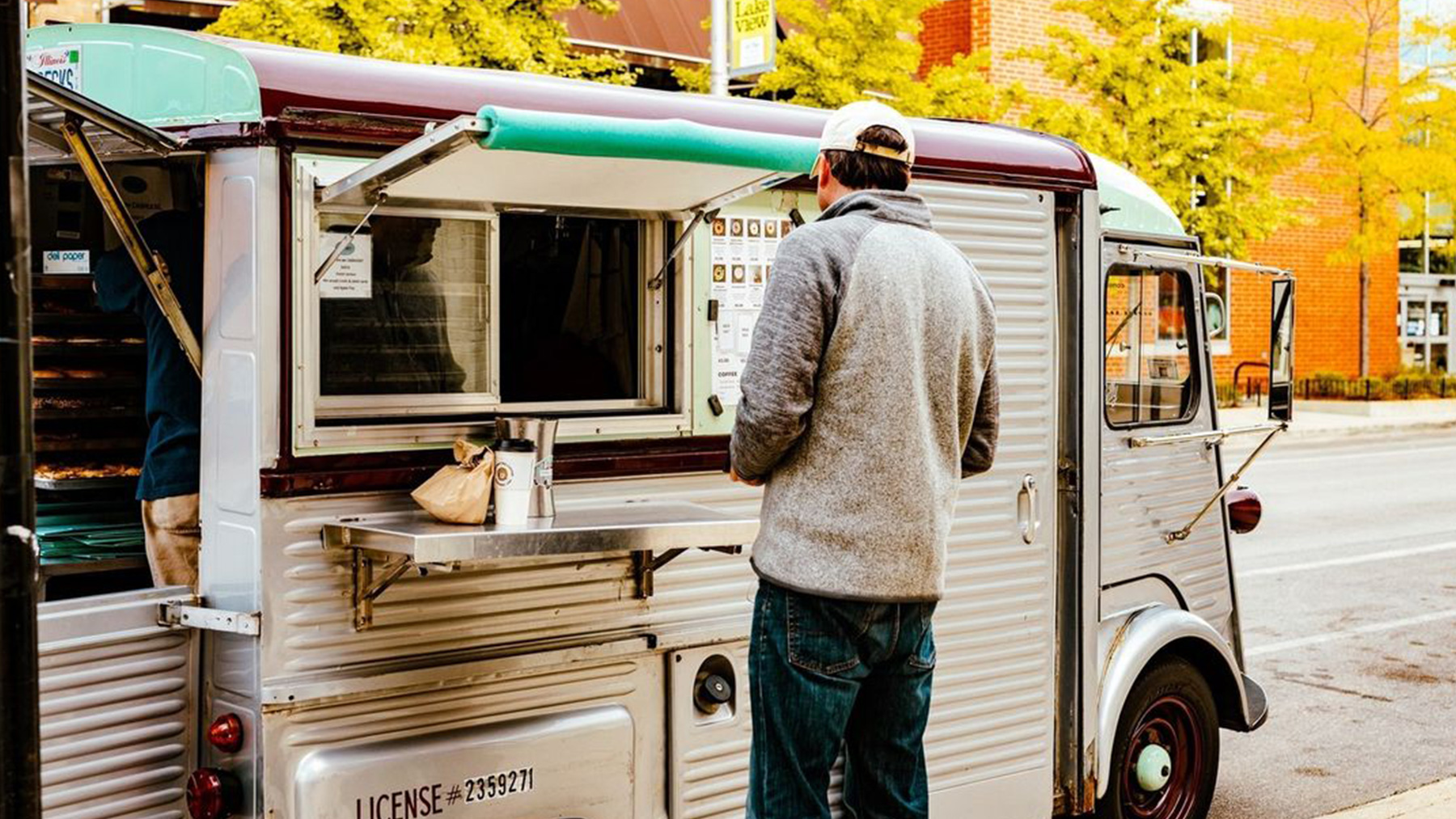 Customer ordering at an outdoor food truck.