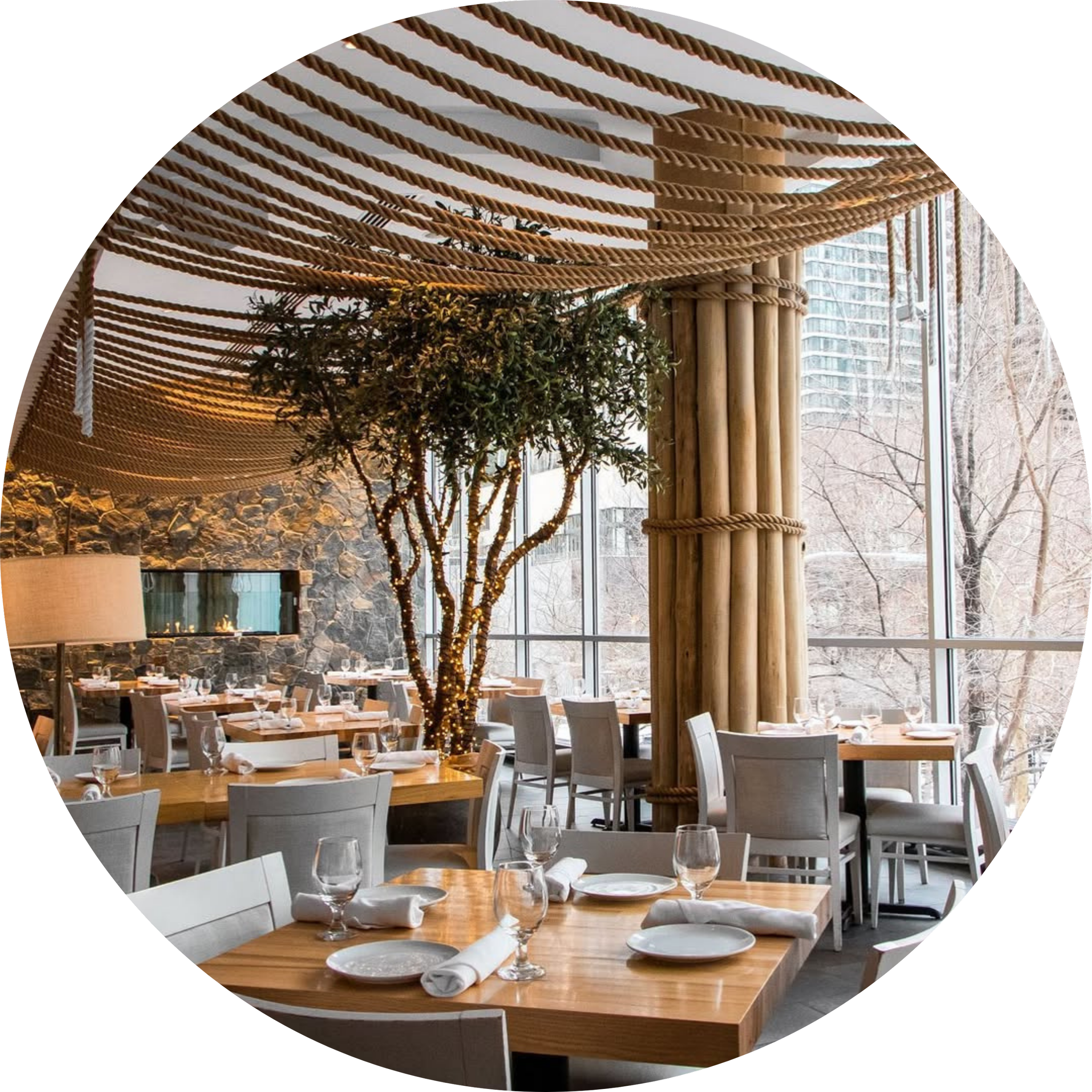 Bright modern restaurant dining room with floor-to-ceiling windows.
