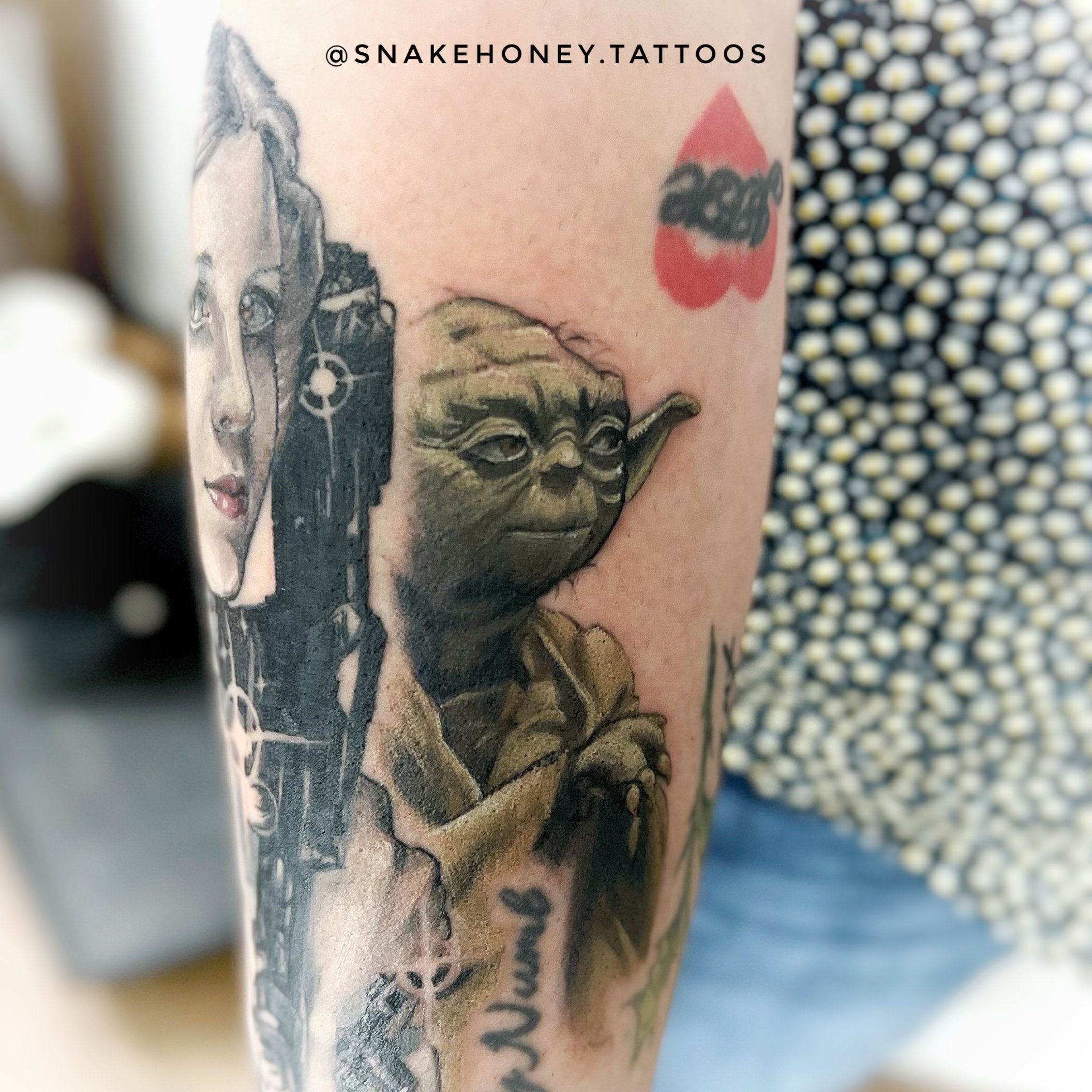 Tattoo featuring Yoda and additional elements on arm