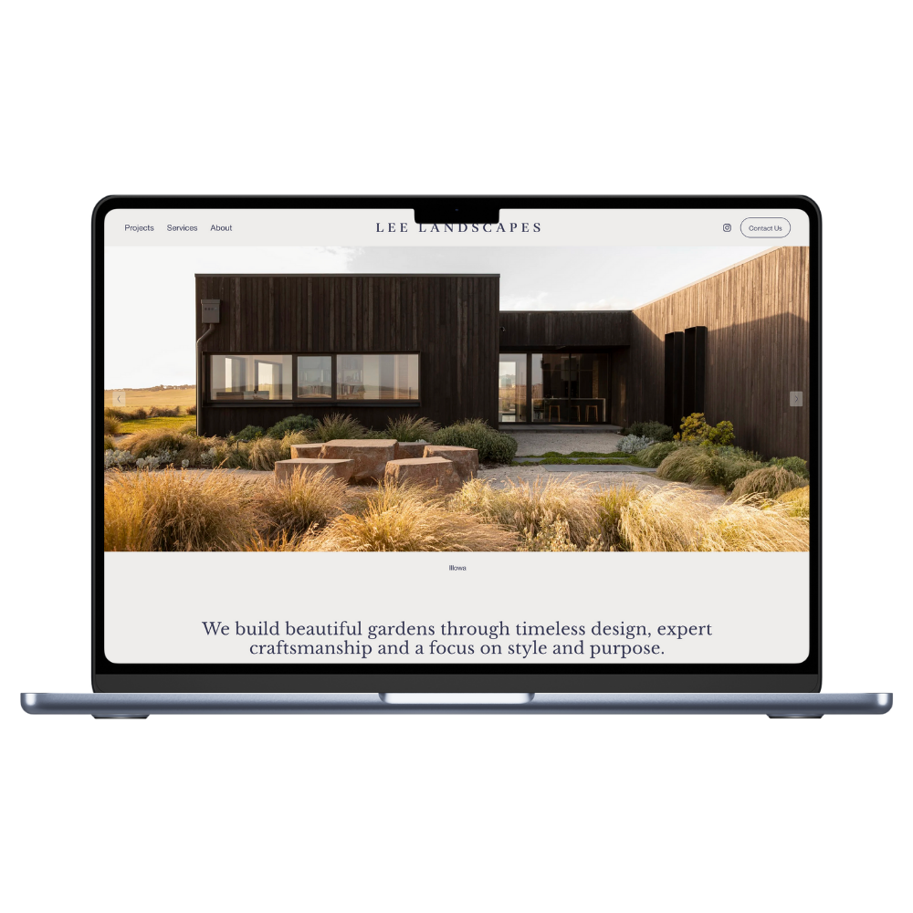 Laptop displaying a website for Lee Landscapes, featuring a modern black and wood exterior house surrounded by landscaped garden with plants and stone seating.