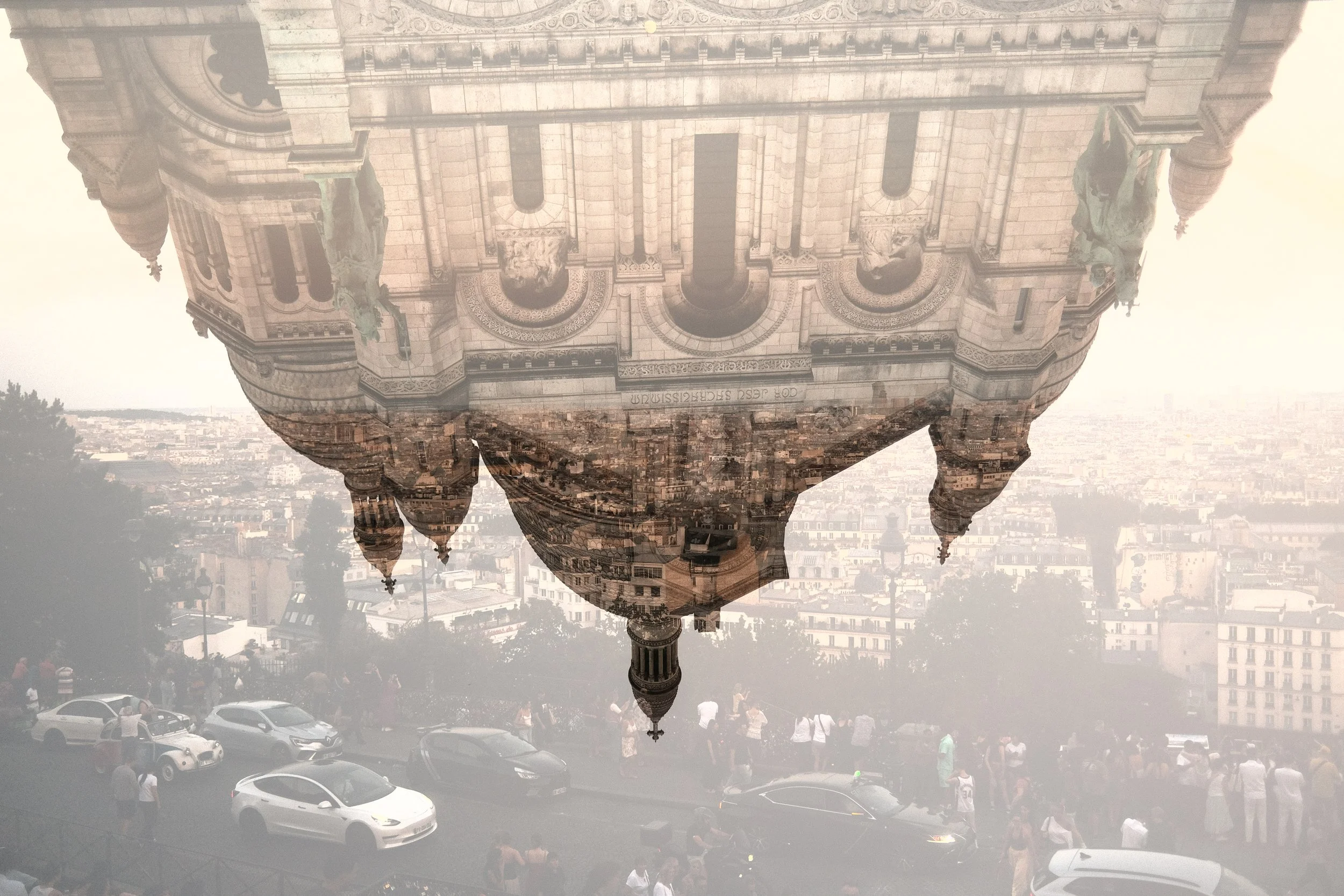 Reflection of ornate historic building with sculptures on its facade, skyscrapers, and a cityscape in the background.