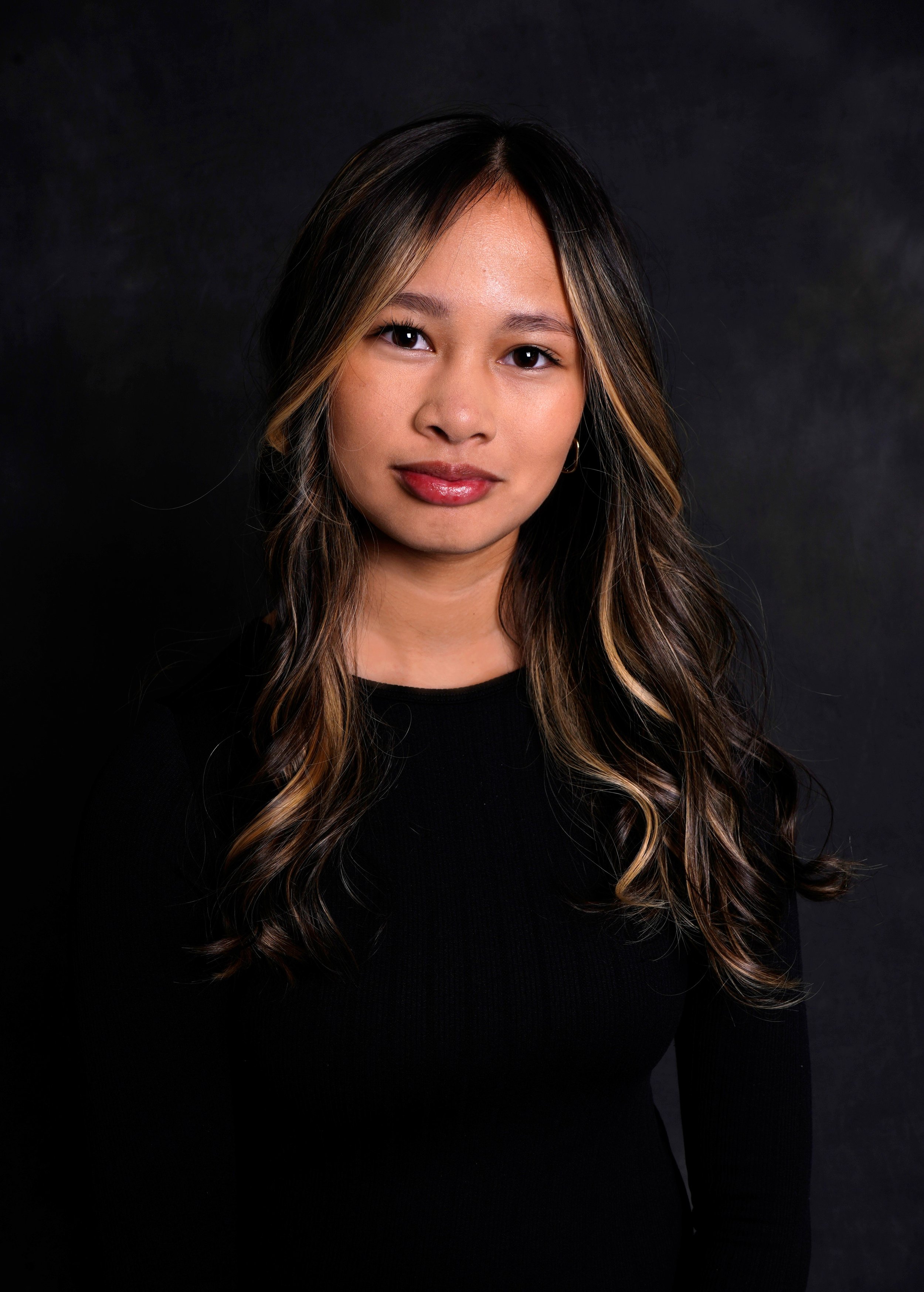 A woman's kids casting photo taken in a Raleigh photography studio for modeling and acting portfolios against a black background