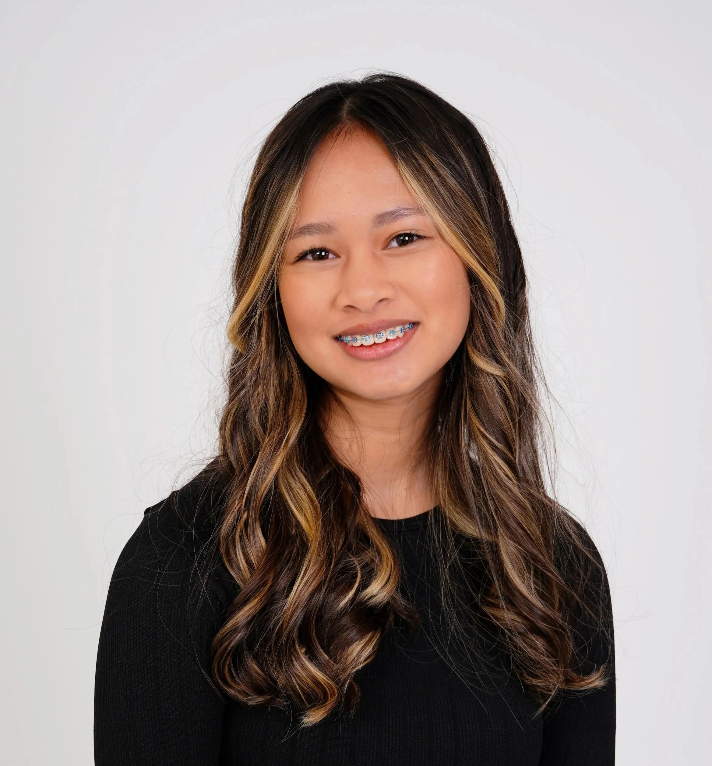 A woman's kids casting photo taken in a Raleigh photography studio for modeling and acting portfolios against a whitebackground