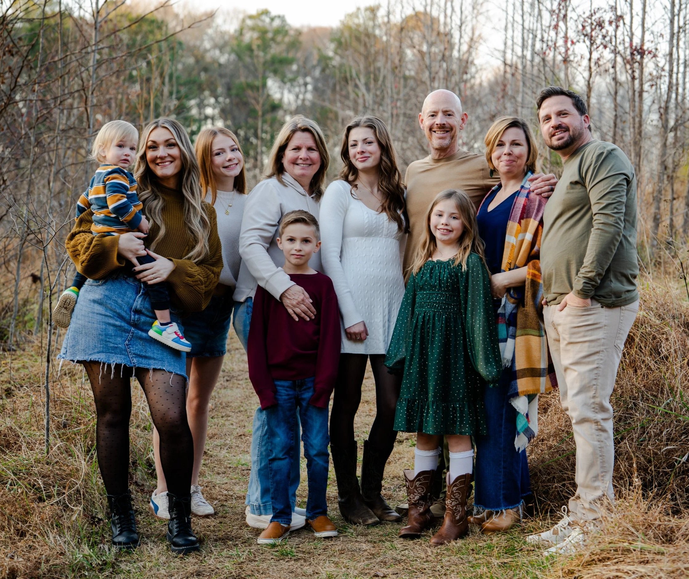 A family of 10 poses at Annie Wilkerson Nature Preserve, Raleigh, North Carolina for family photos of grandchildren, parents, and grandparents.