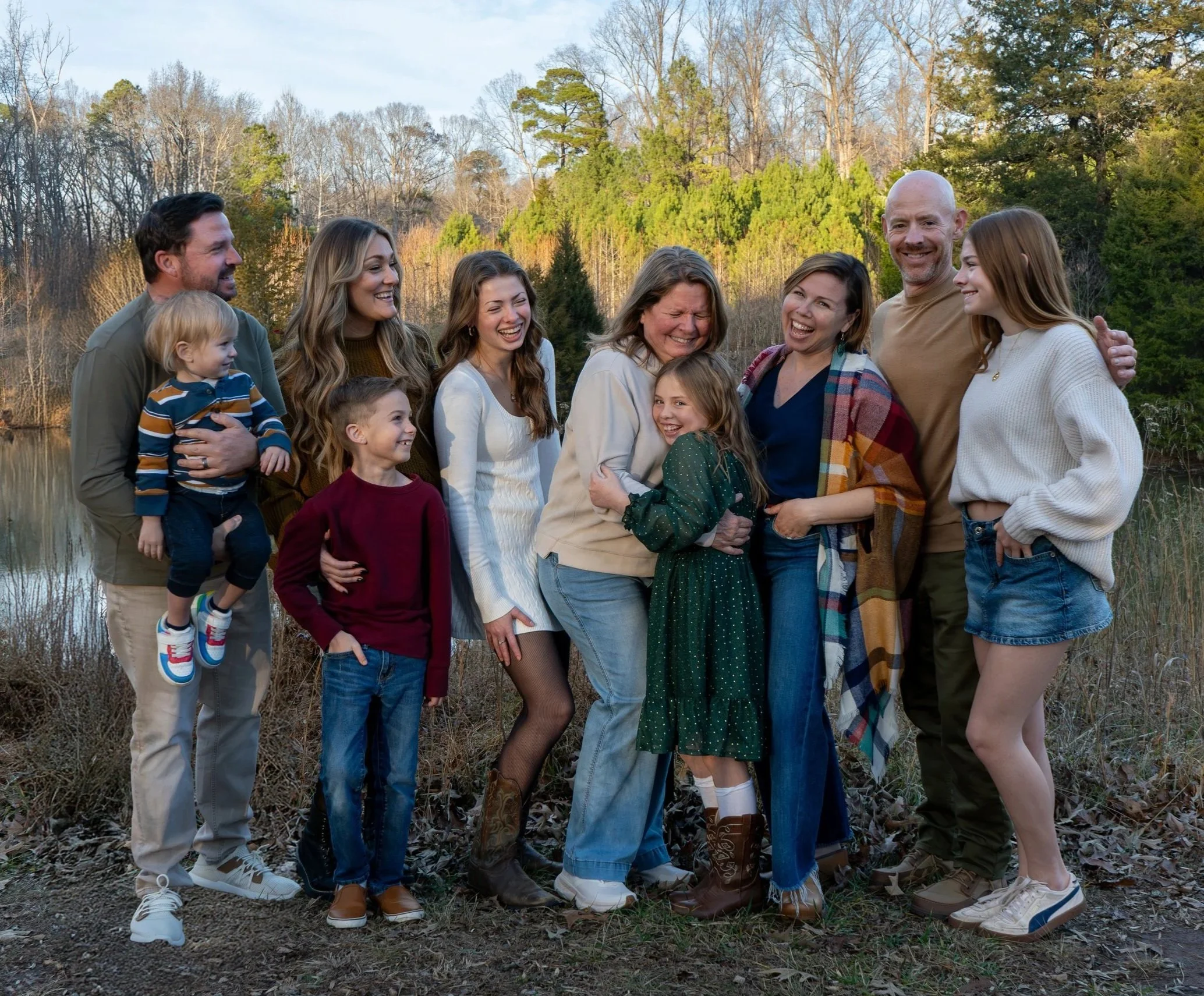 A family of 10 poses at Annie Wilkerson Nature Preserve, Raleigh, North Carolina for family photos of grandchildren, parents, and grandparents.