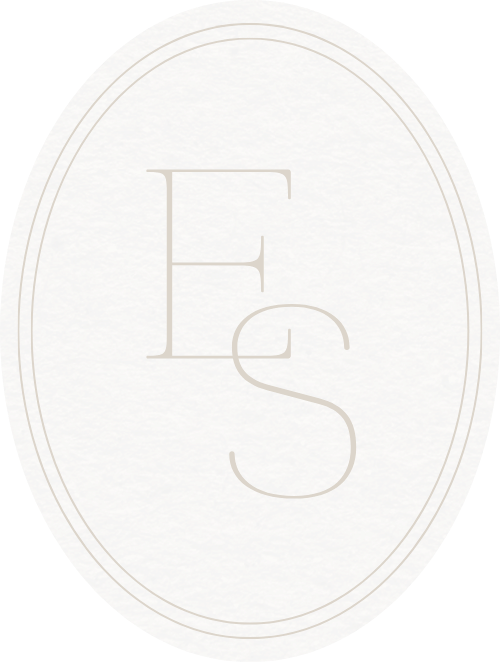A textured stone background with a white oval border and the initials "E S" in the center.