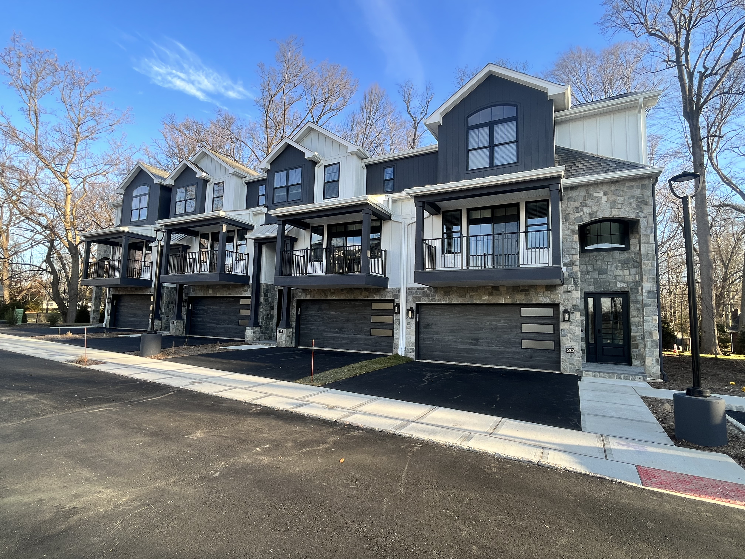 Commercial townhouse complex with stone and white siding built by Coastal Creations NJ commercial contractor.