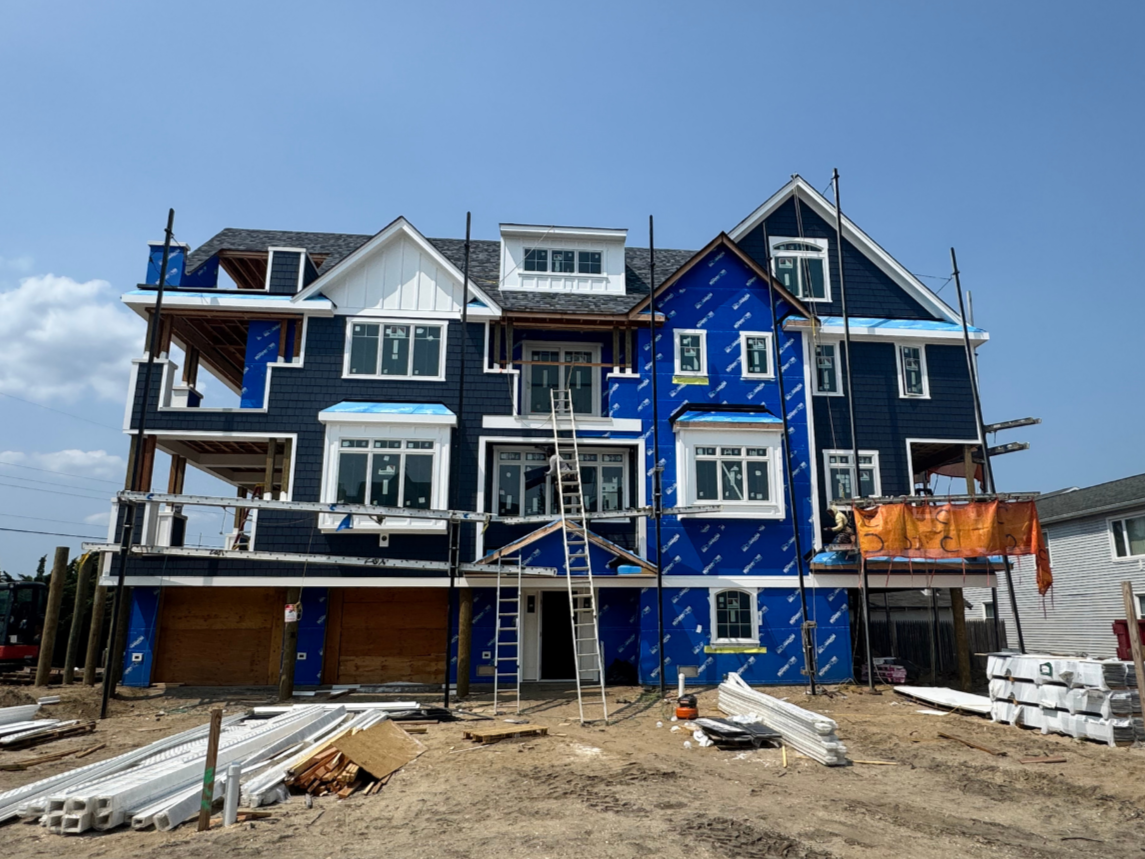 Custom home under construction in Seaside Park, New Jersey with blue siding by Coastal Creations LLC