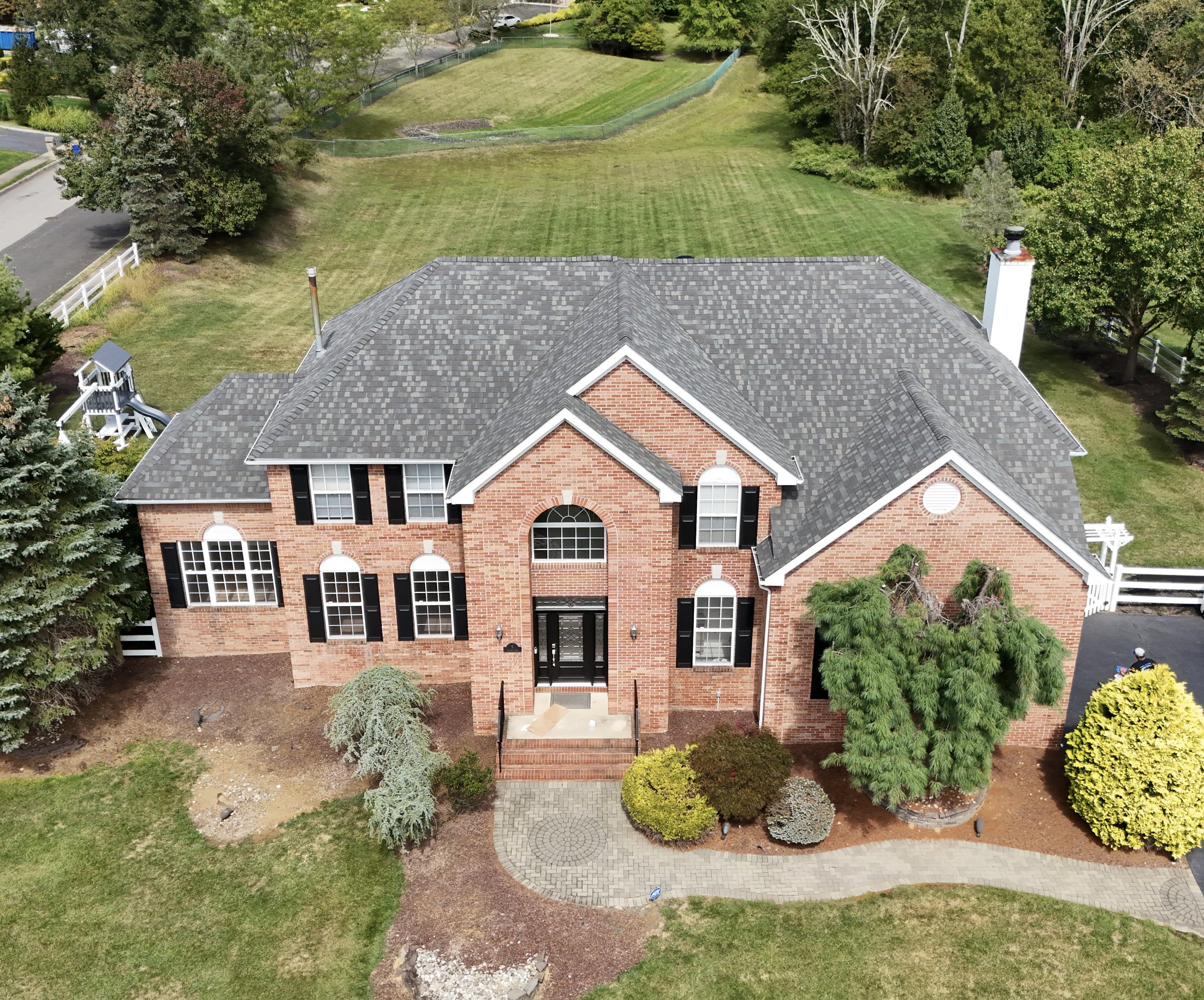 Aerial view of Marlboro, New Jersey home with new gray architectural shingle roof installed by Coastal Creations
