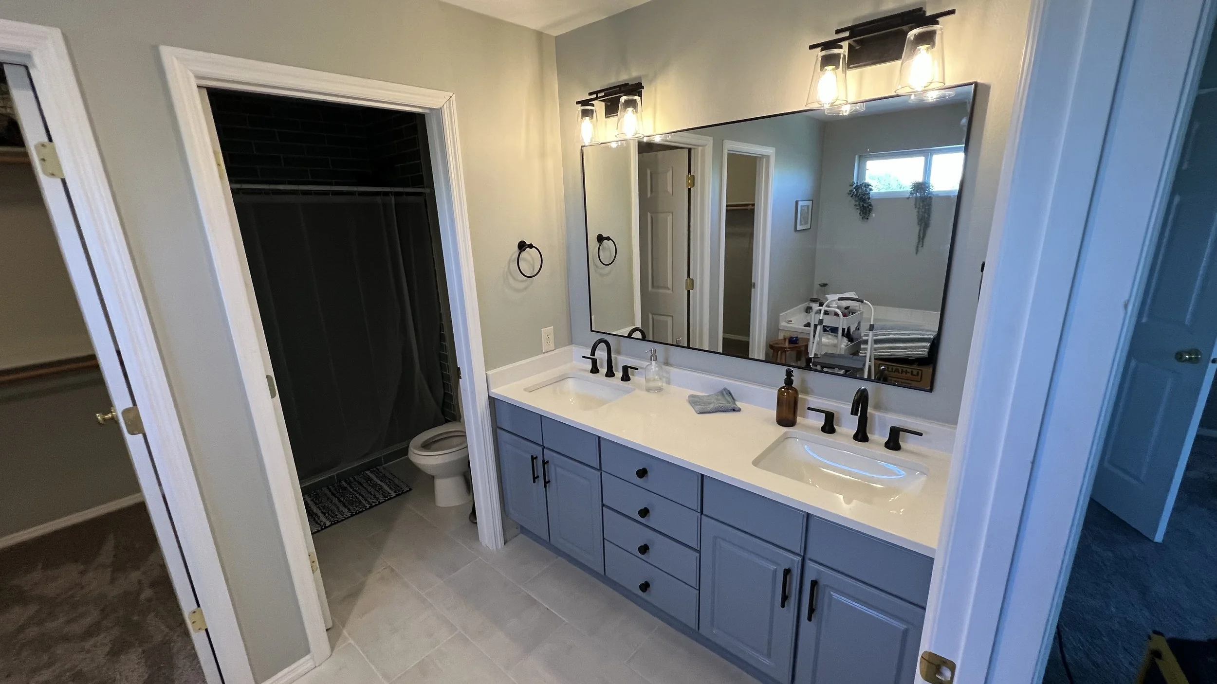 Fresh tile, refinished vanity, and new countertops and fixtures for this one!