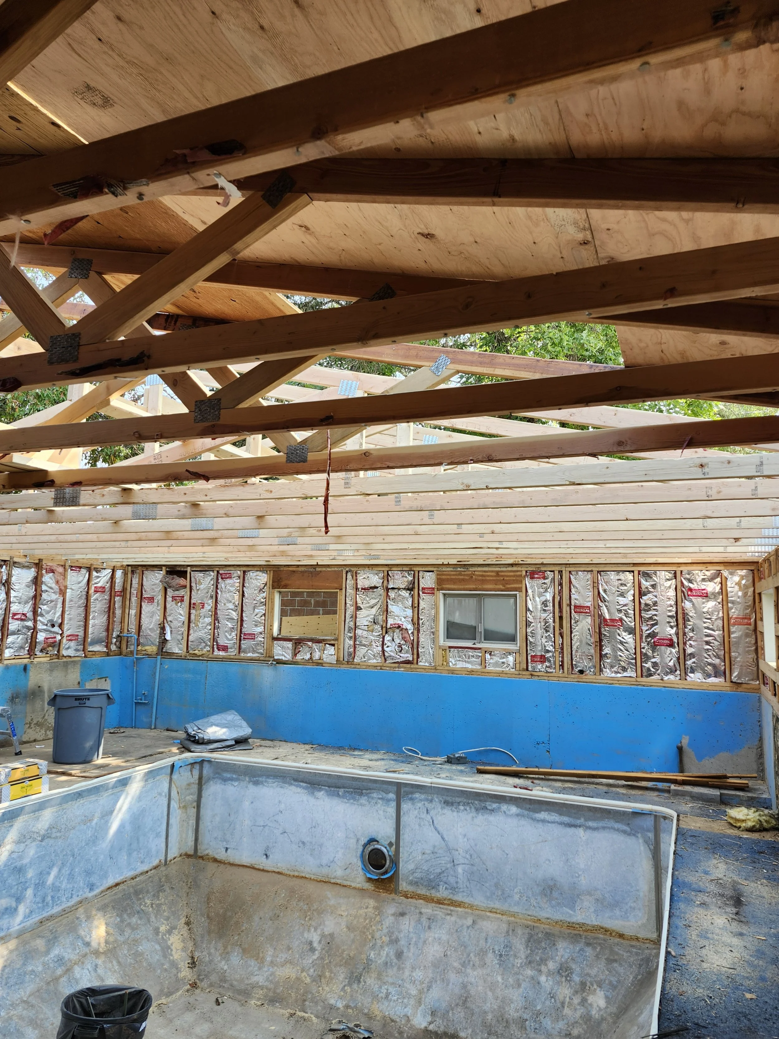 The roof of this old indoor pool was well on its way to collapsing and taking the building with it. We re-framed the roof with new trusses and straightened and reinforced the walls  