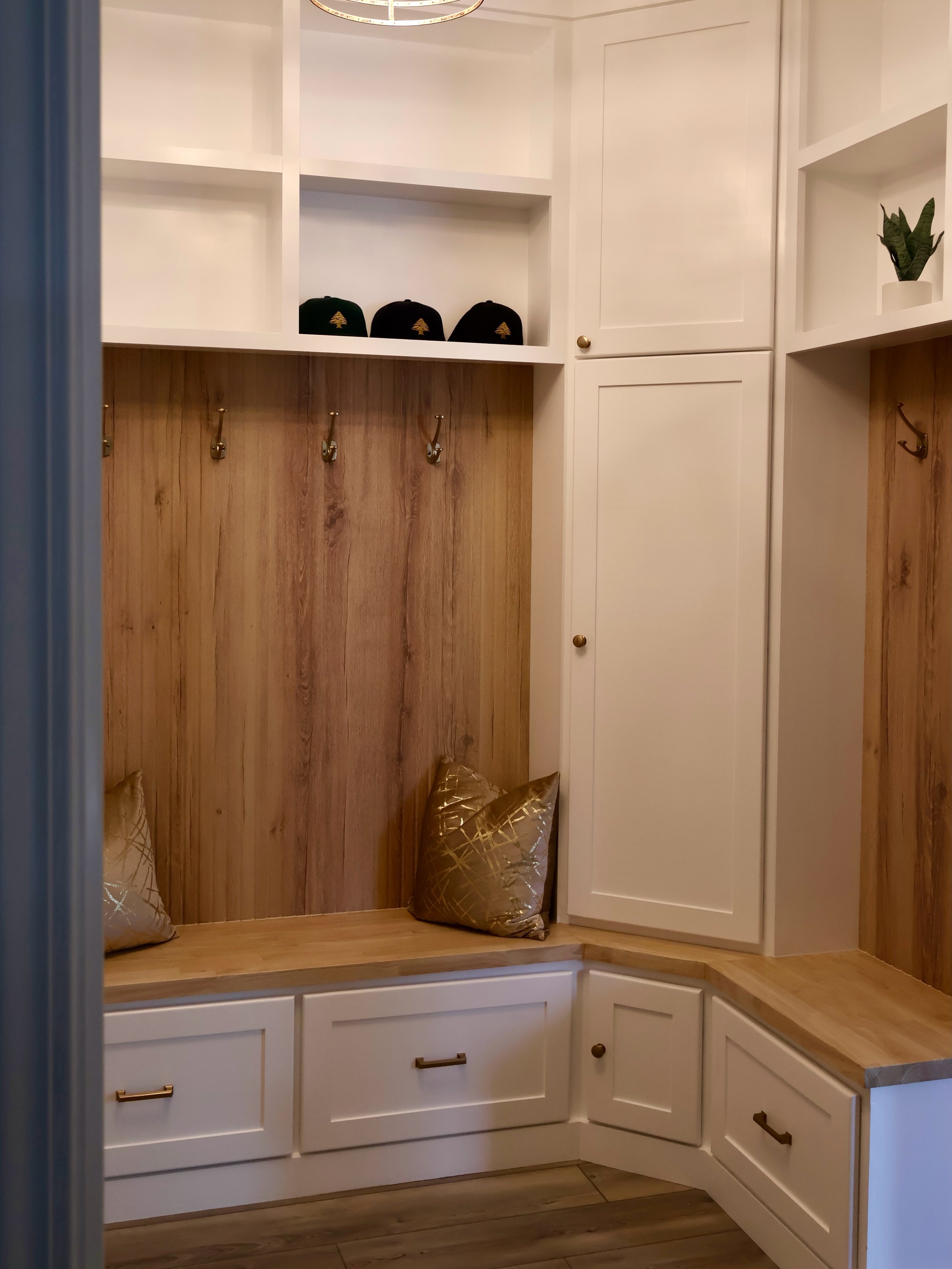 Transforming your mudroom into a perfect blend of style and function!

In the Raleigh area, we completely removed an old wall to create this fresh, open mudroom.

We replaced outdated metal shelving with custom corner base cabinets&mdash;featuring fo