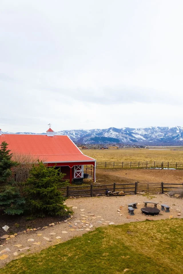 view of the ranch house with the mountains in background