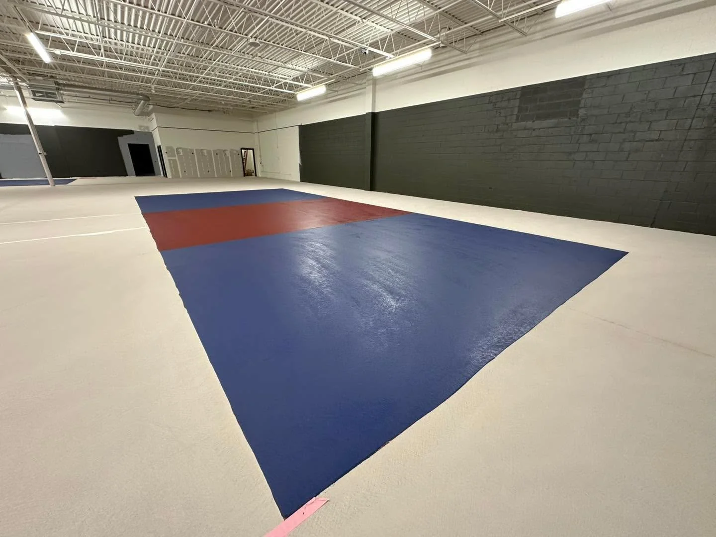 First coat of paint is down! 

We went with an auburn kitchen area, a dark blue playing surface, and a soft sand color throughout the rest of the space. The goal was to create courts that feel both unique and familiar and we love how it&rsquo;s start